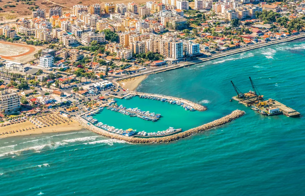Sea port city of Larnaca, Cyprus. View from the aircraft to the coastline, beaches, seaport and the architecture of the city of Larnaca.