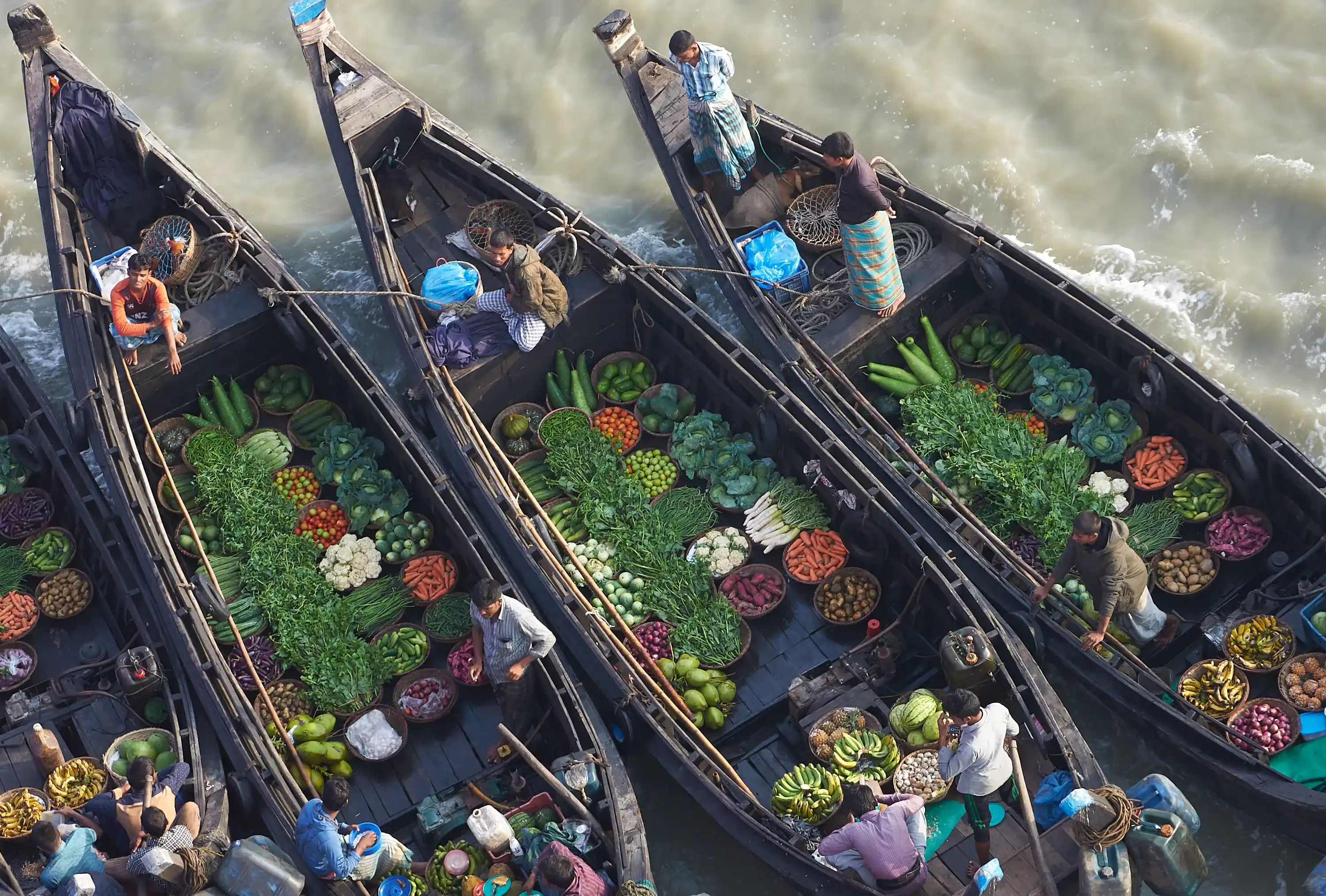 Chittagong / Bangladesh - 13 March 2017: Floating bazar in Bangladesh, salesmen offering food, fresh vegetables, meat.