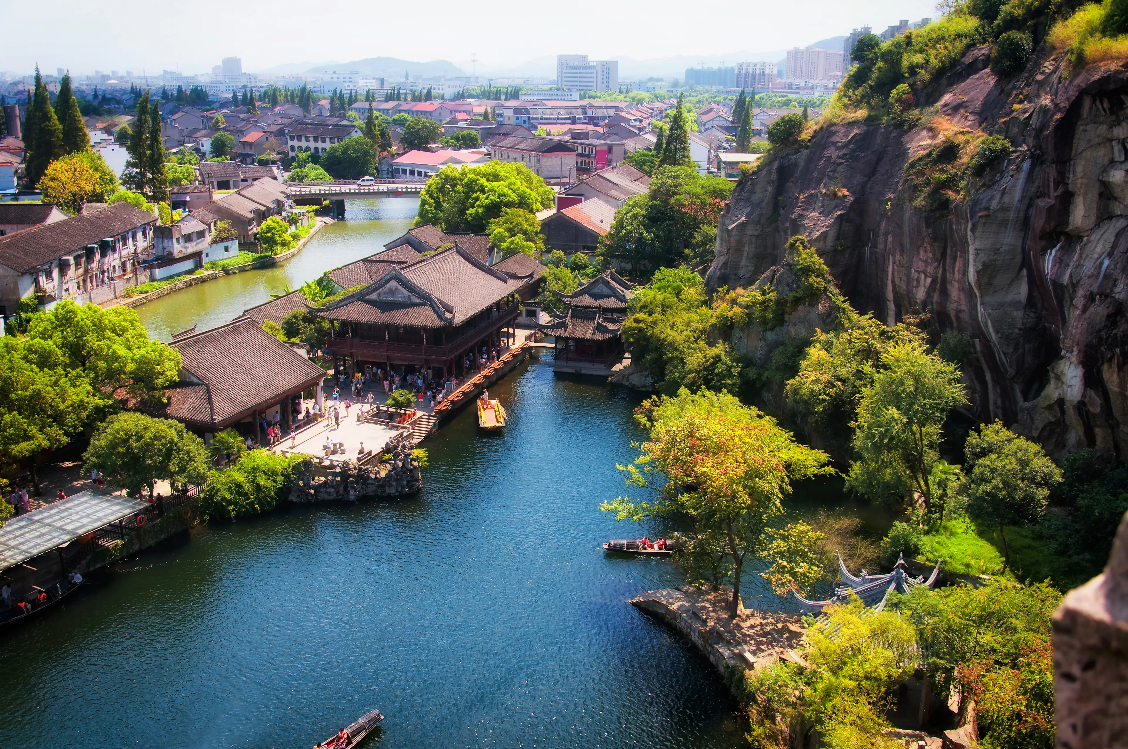 An aerial view high above east lake scenic area and the city of shaoxing china in zhejiang province in the background on a sunny summer day.