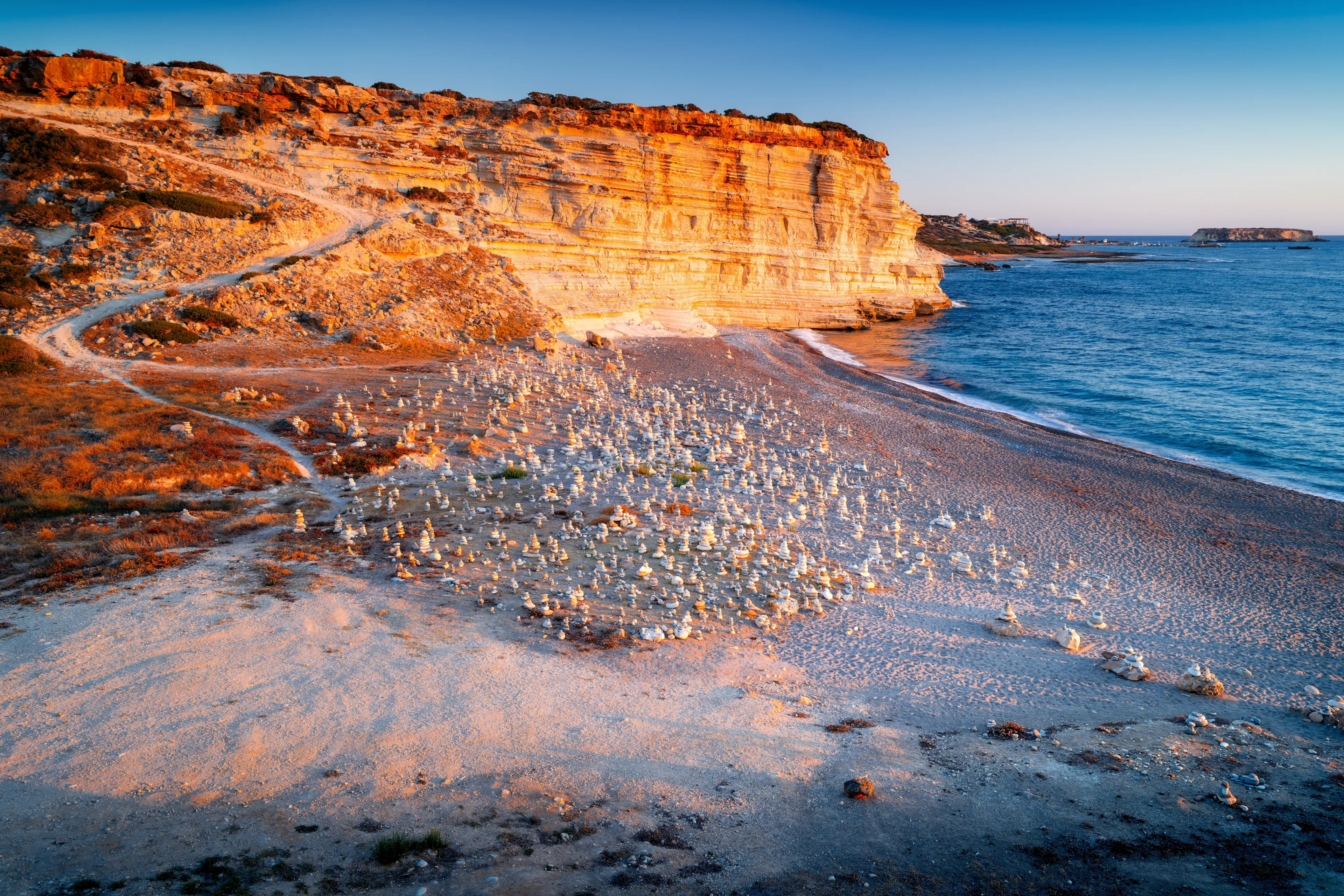 The most beautiful beach in Cyprus, nestled in a bay with cliffs at sunset. White River Beach, Mediterranean Sea, Peyia, Cyprus.