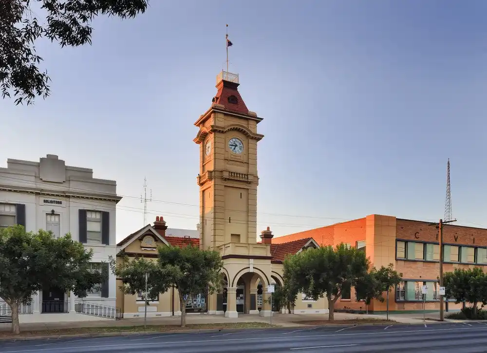 Town hall facade facing street with tall clock tower at sunrise in a small regional town Mildura, of Australia. Town hall facade facing street with tall clock tower at sunrise in a small regional town Mildura, of Australia.