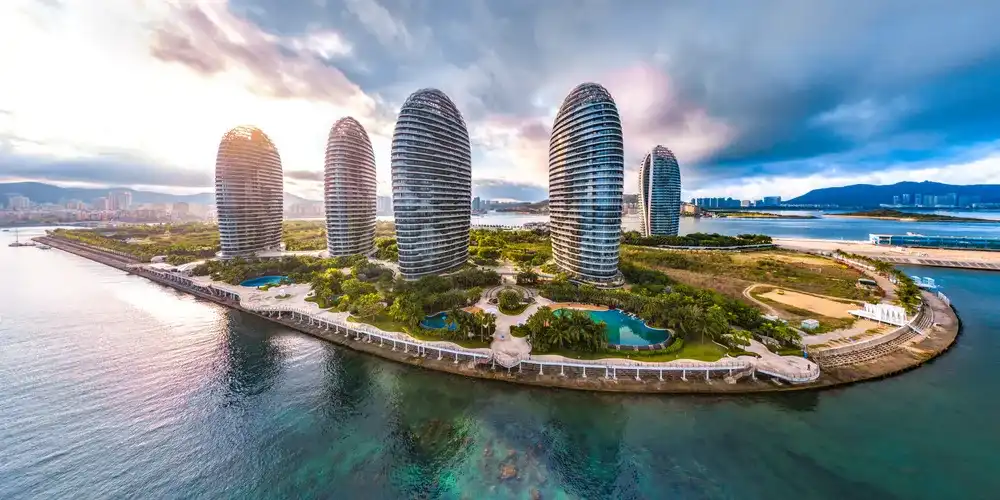 Sanya Phoenix Island, an Artificial Archipelago with Modern Architecture and Cruise Home Port, a Landmark Building for Sanya City, Hainan Province, China. Sanya Bay Sunrise Aerial View.