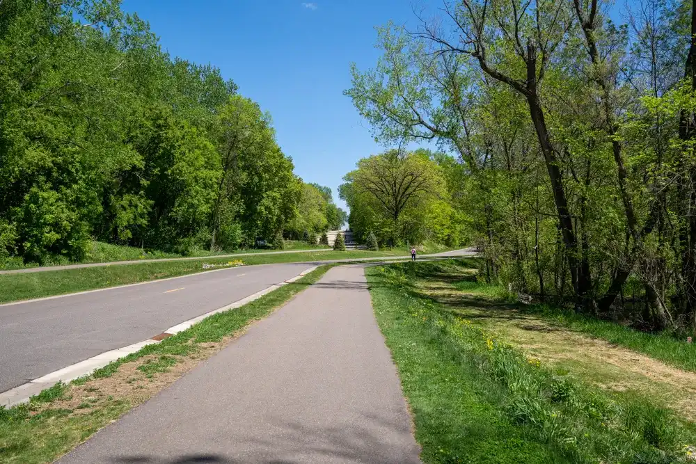 Walking trails near the park road in Clifton E French Regional Park, part of Three Rivers Park District in Plymouth Minnesota Walking trails near the park road in Clifton E French Regional Park, part of Three Rivers Park District in Plymouth Minnesota