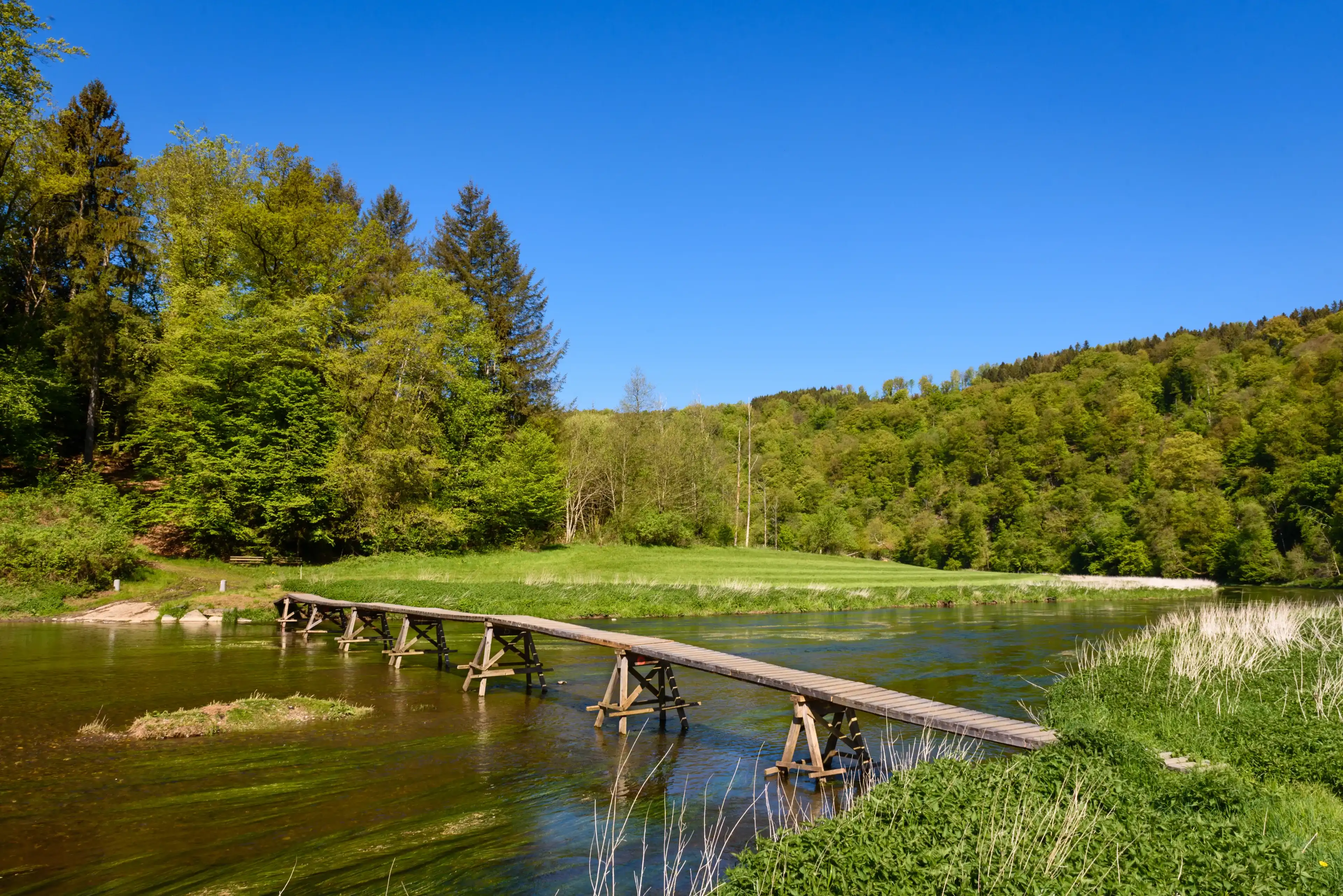 Wooden footbridge across Semois river in Cugnon (Bertrix), Luxembourg province, Ardennes region, Wallonia, Belgium.
