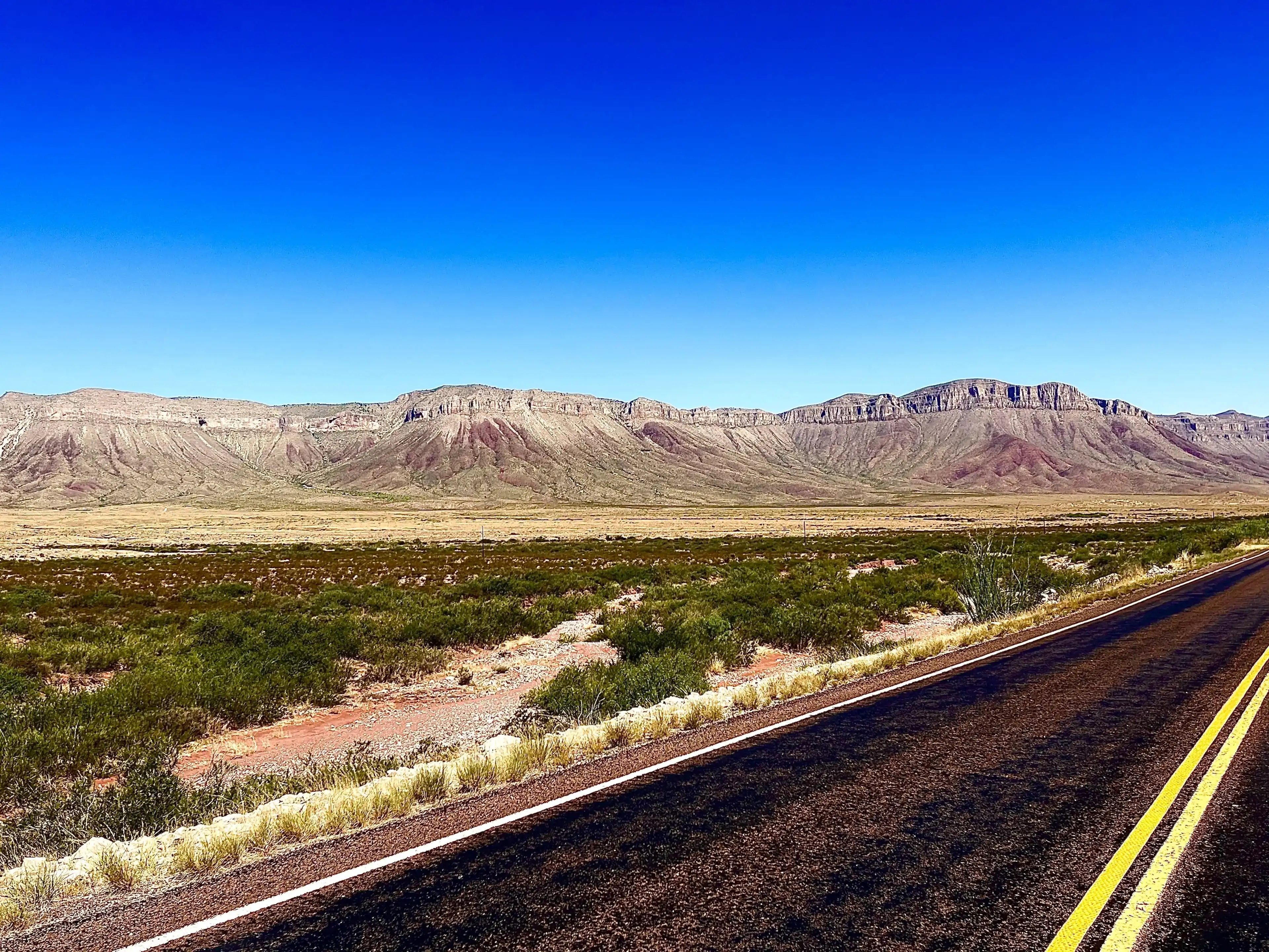Clear blue skies, plateaus, and endless road meet in West Texas near Van Horn. Clear blue skies, plateaus, and endless road meet in West Texas near Van Horn.