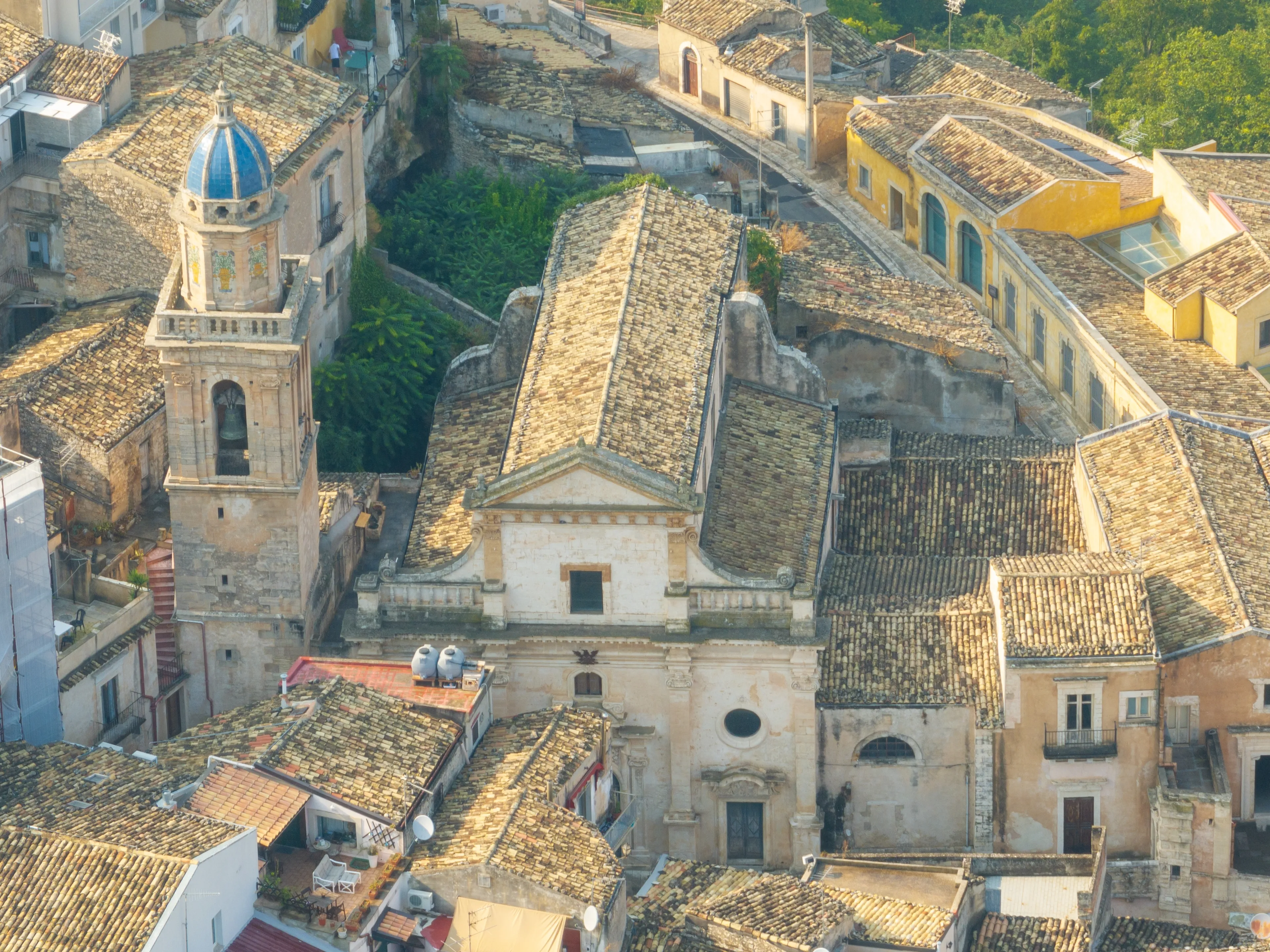 Blue dome of the Baroque style Chiesa di Santa Maria dell’Itria covered with eight Caltagirone terracotta panels decorated with large rococo flower vases in Ragusa Ibla Sicily Italy.