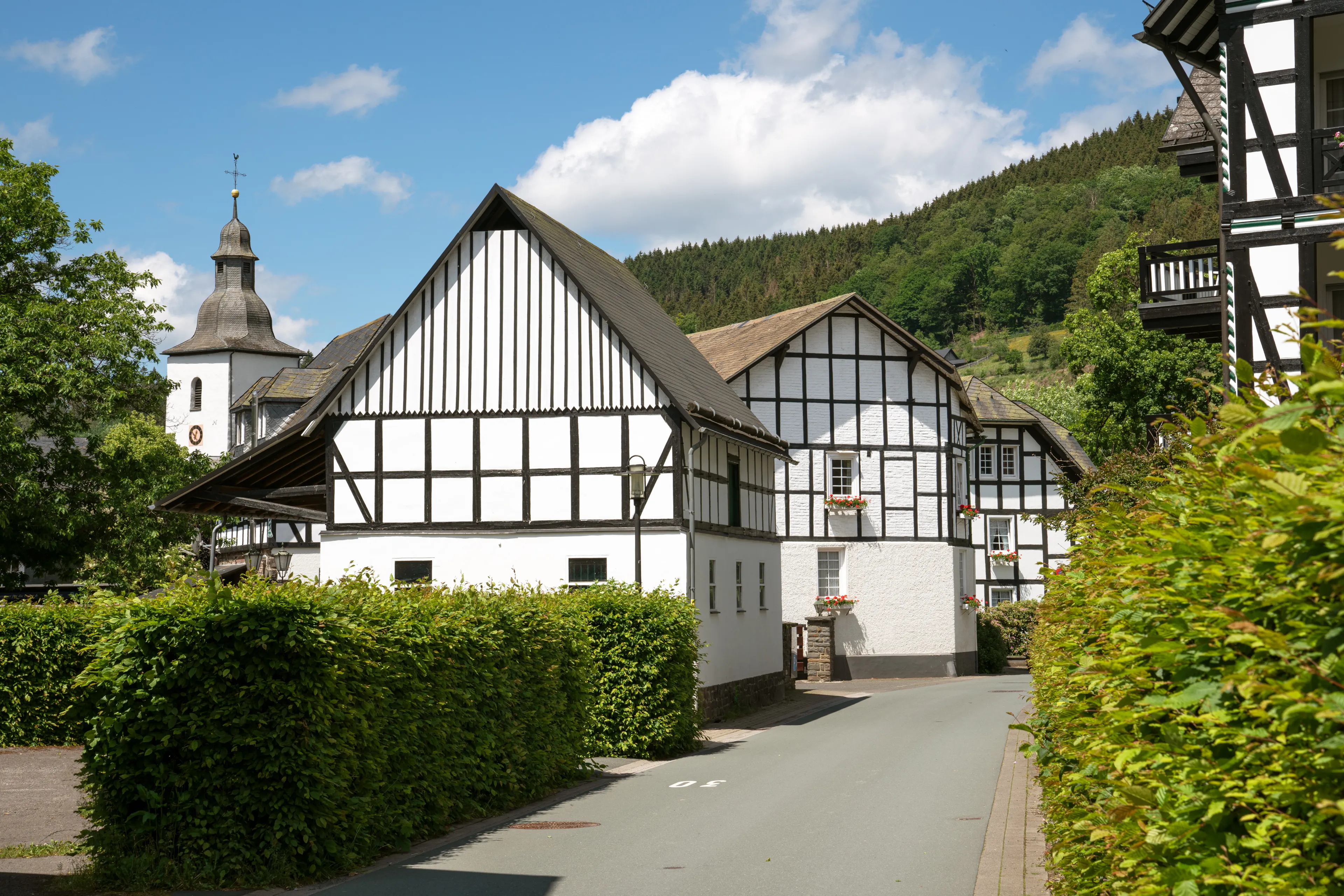 Image of old half-timbered houses against blue sky in summertime, Oberkirchen, Schmallenberg, Sauerland, Germany