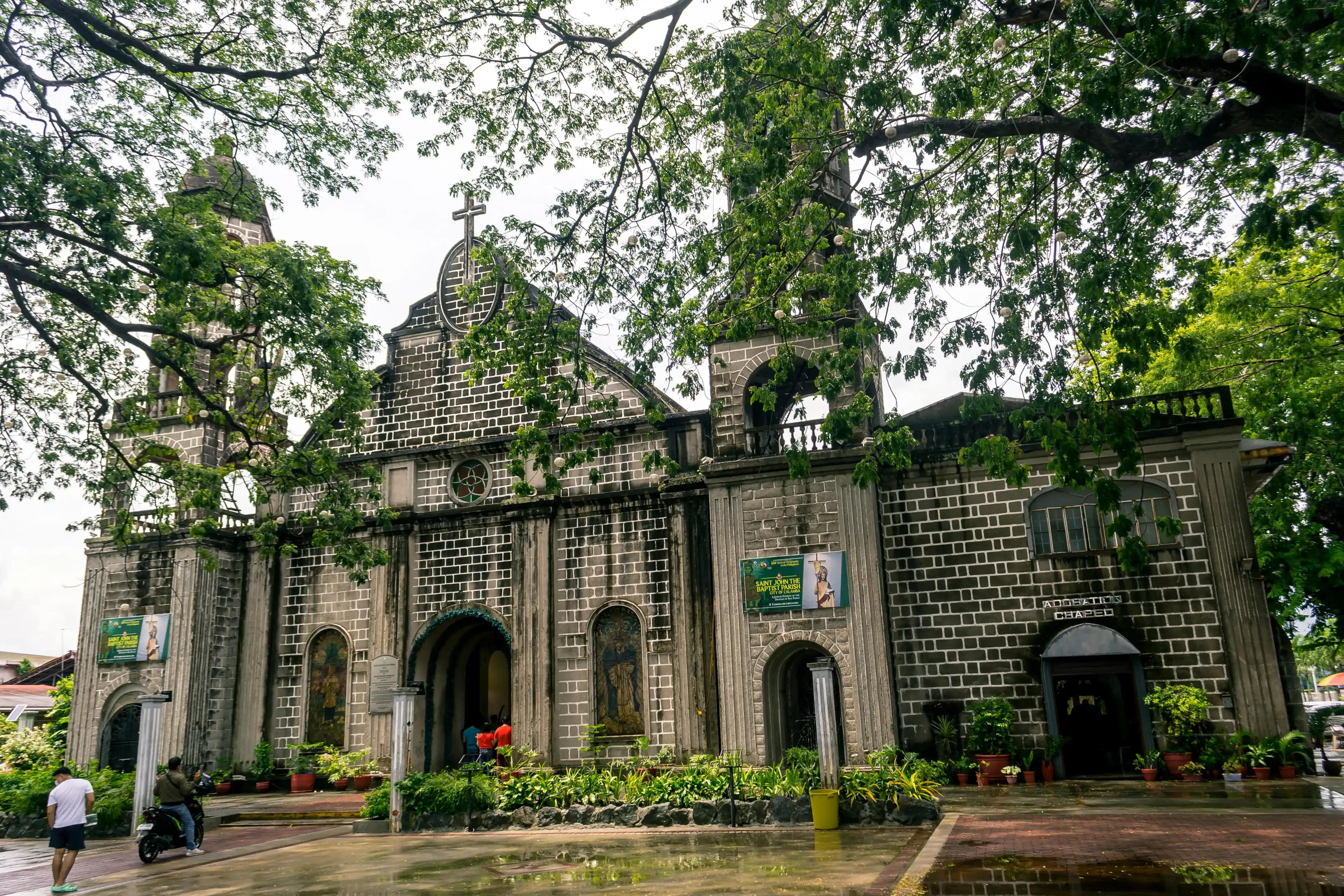 Calamba, Laguna, Philippines - June 2021: Saint John the Baptist Parish Church, a stone Roman Catholic Church of Baroque style architecture. Calamba, Laguna, Philippines - June 2021: Saint John the Baptist Parish Church, a stone Roman Catholic Church of Baroque style architecture.