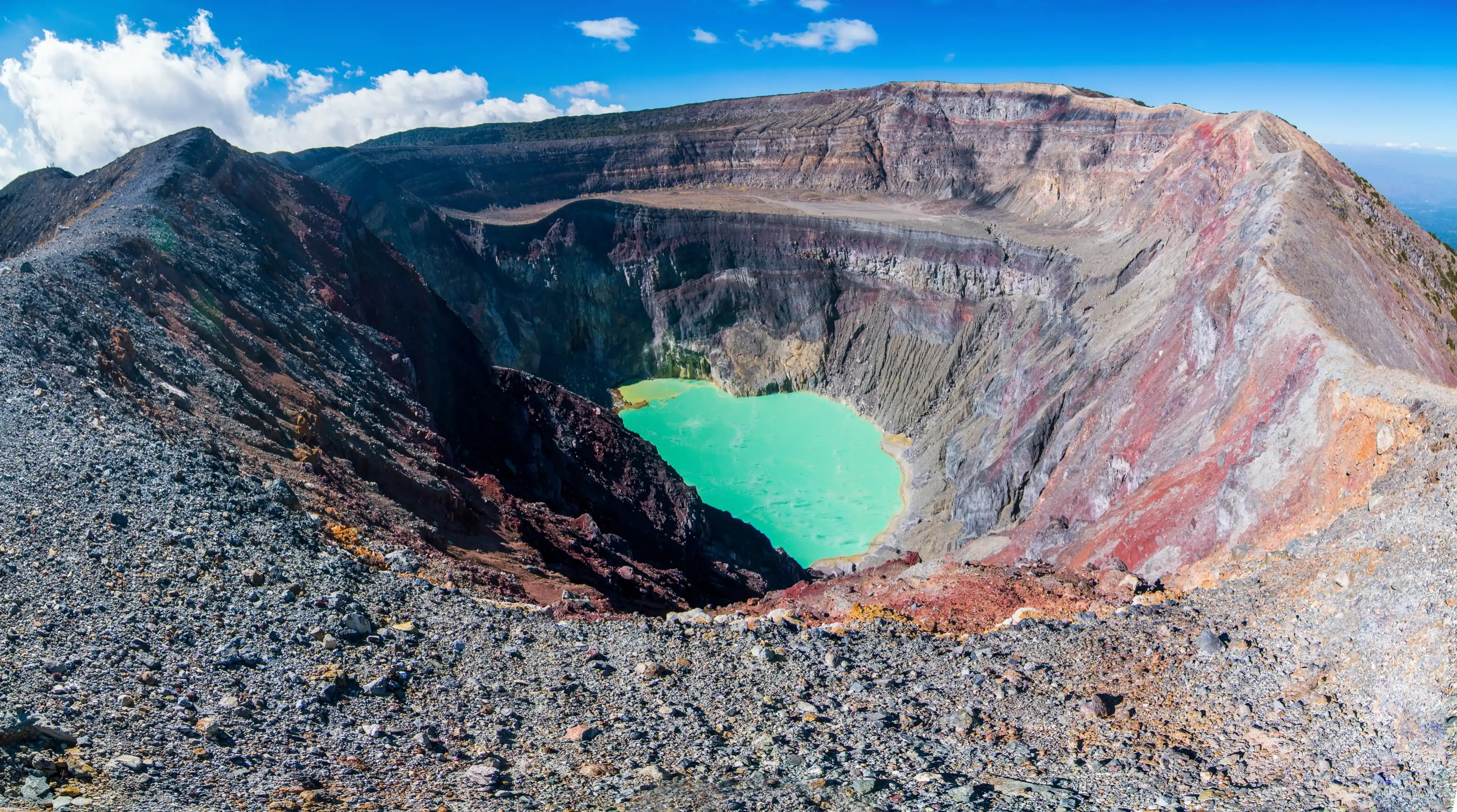 Panorama of Santa Ana volcano crater with turquoise volcanic lake.