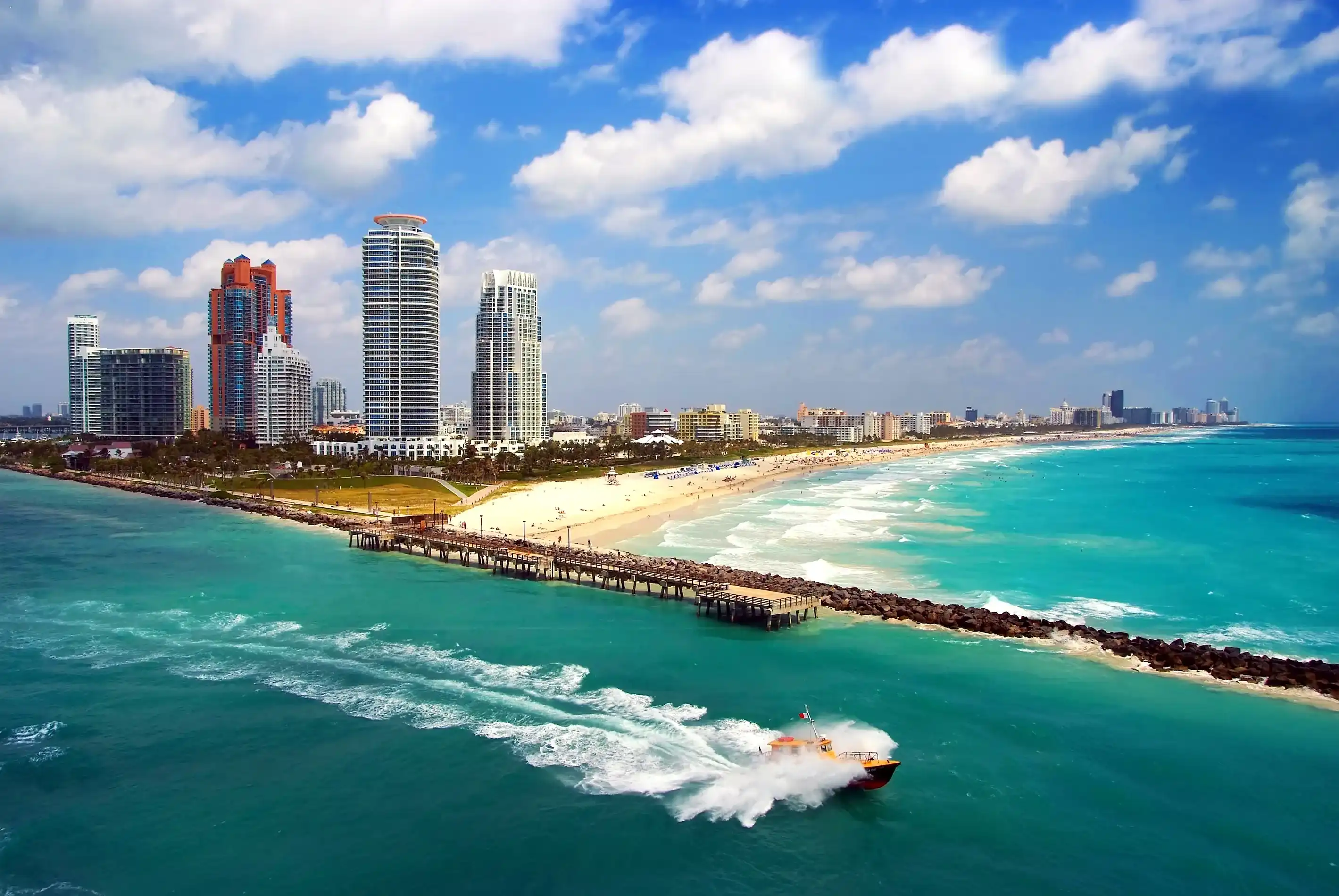 Aerial view of South Miami Beach with Pilot boat sailing next to the city line