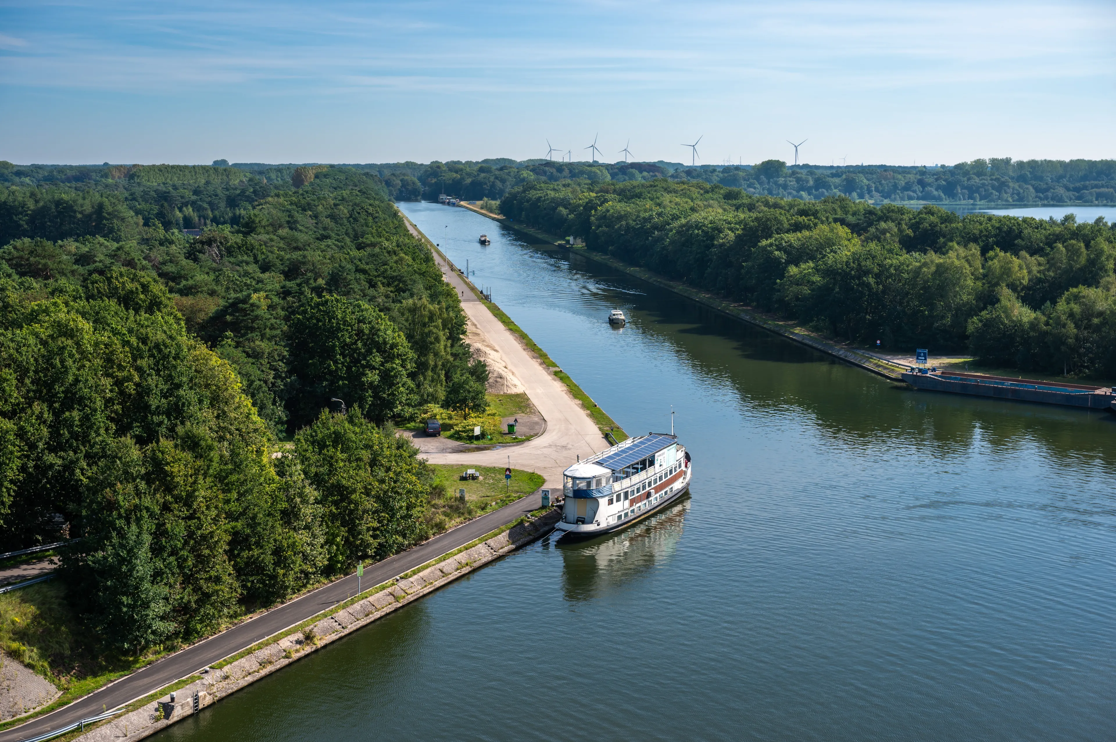 Dessel, Antwerp Province, Belgium, September 7, 2023 - Tower view over the woods and the canal with a ship