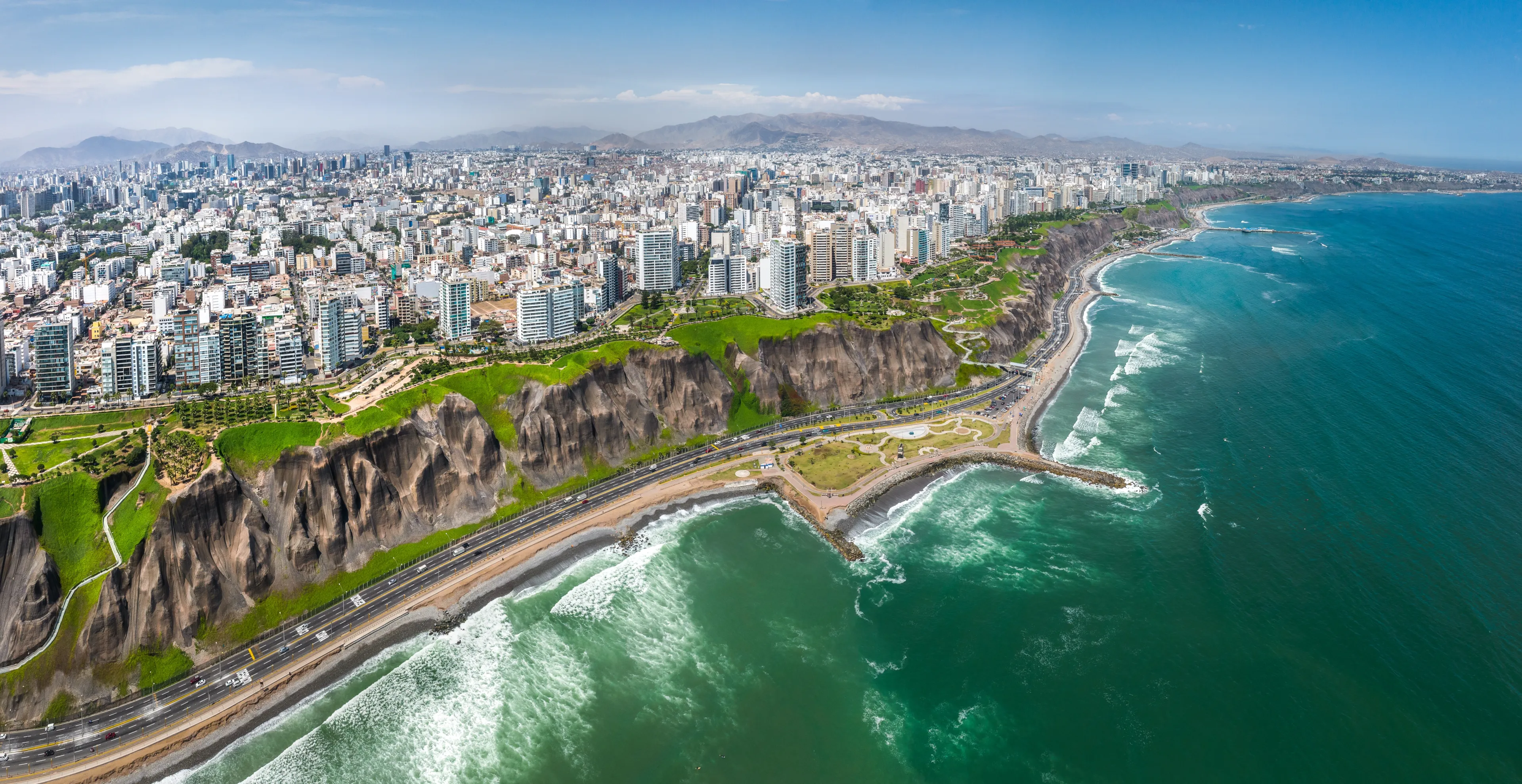 LIMA, PERU: Aerial view of Miraflores town, cliff and the Costa Verde high way