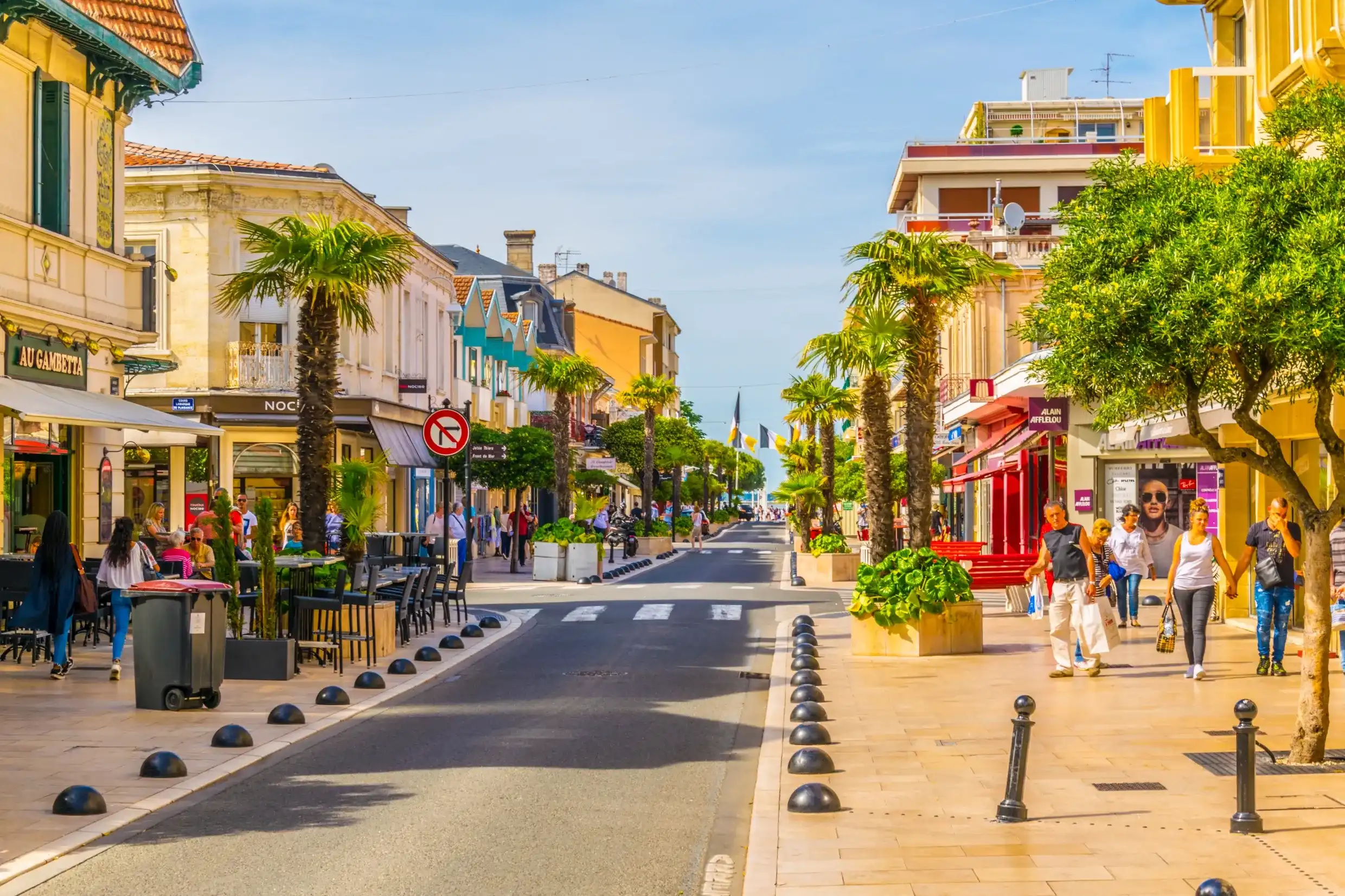 ARCACHON, FRANCE, MAY 15, 2017: Main pedestrian alley leading to a beach in the historical center of Arcachon, France ARCACHON, FRANCE, MAY 15, 2017: Main pedestrian alley leading to a beach in the historical center of Arcachon, France