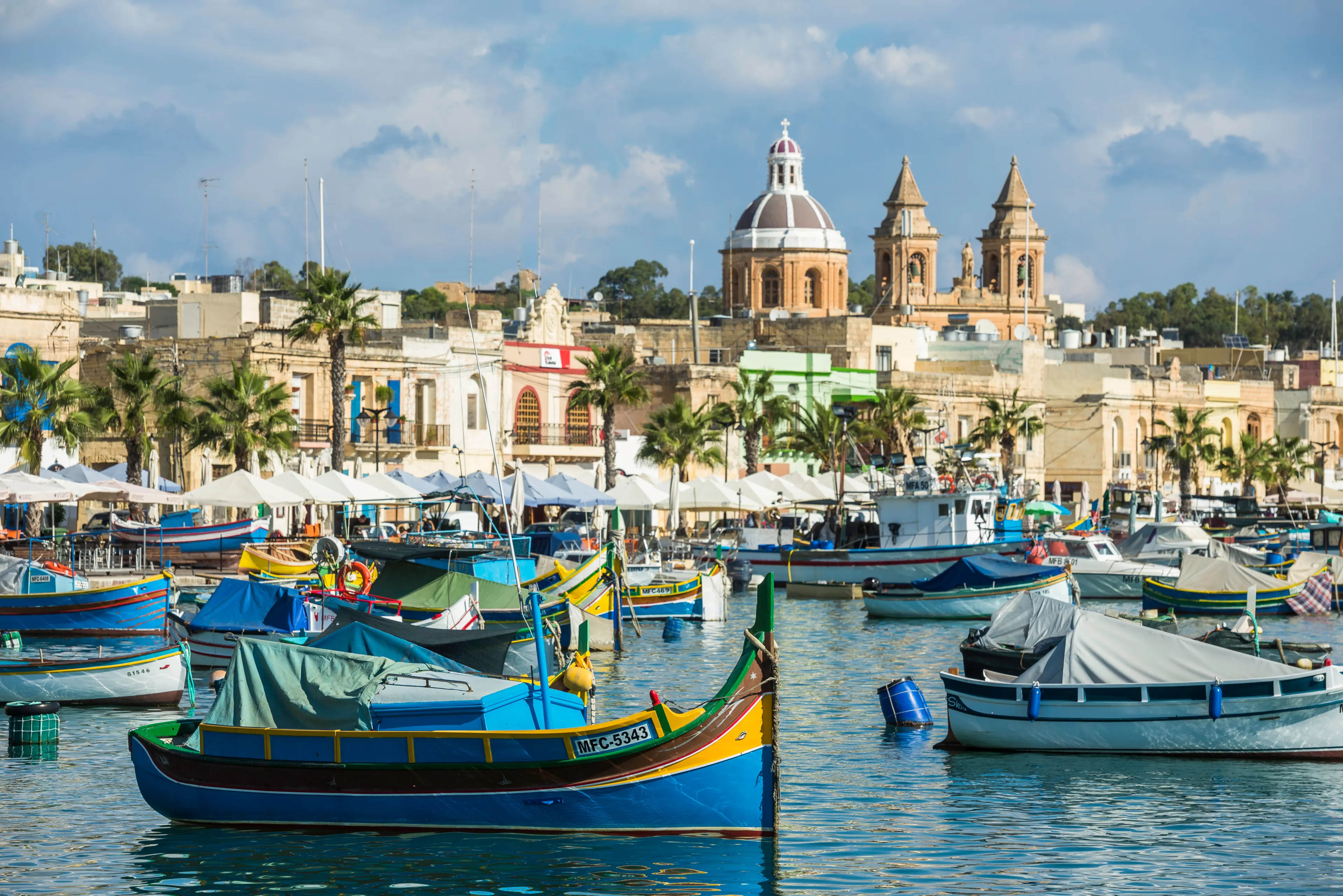 Marsaxlokk / Malta 09/30/2015.Panoramic view of the Marsaxlokk port, with Luzzus typical boats of the Island of Malta