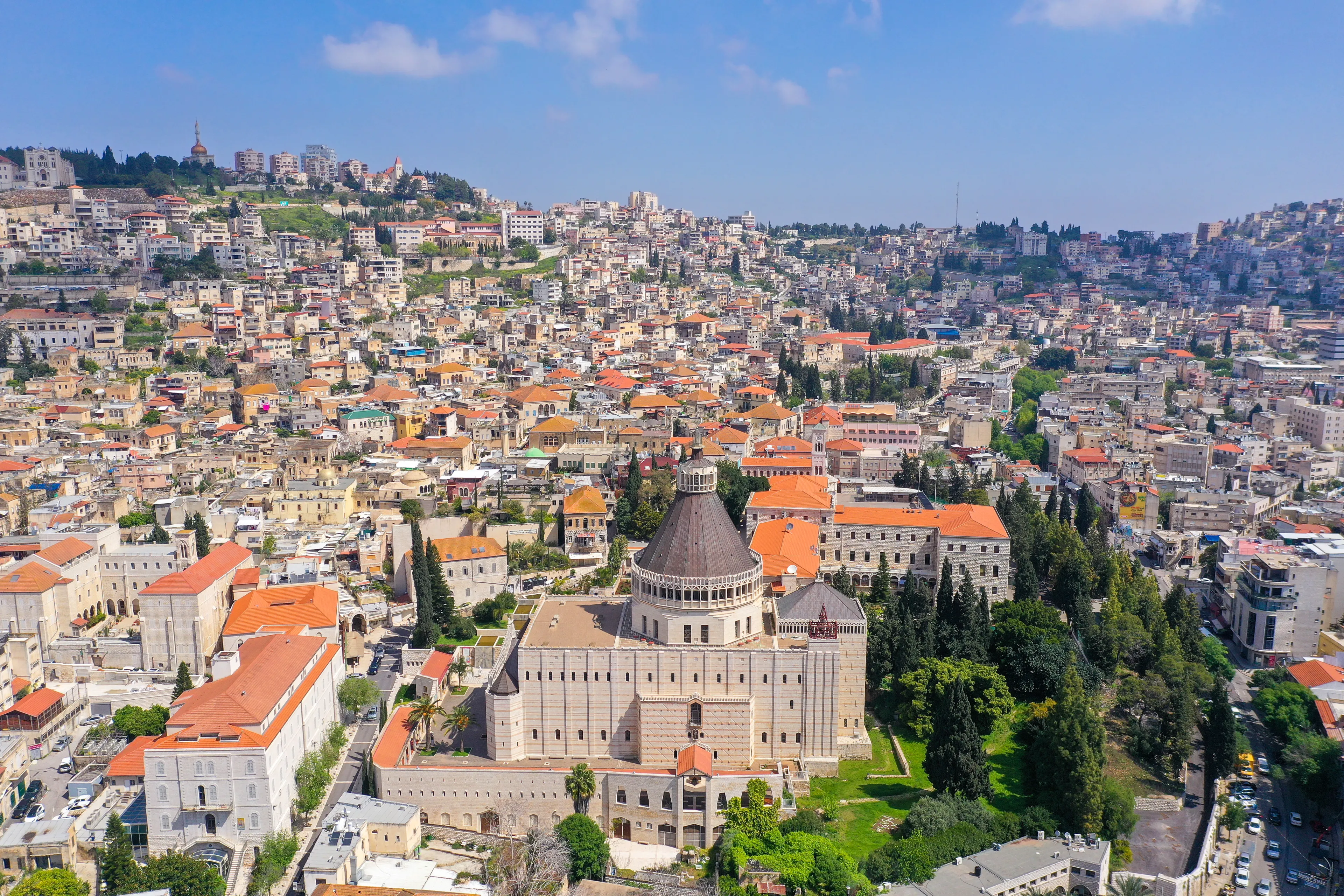 Aerial footage of the Basilica of the Annunciation over the old city houses of Nazareth during Corona Virus lockdown, with no people of traffic in the streets.
