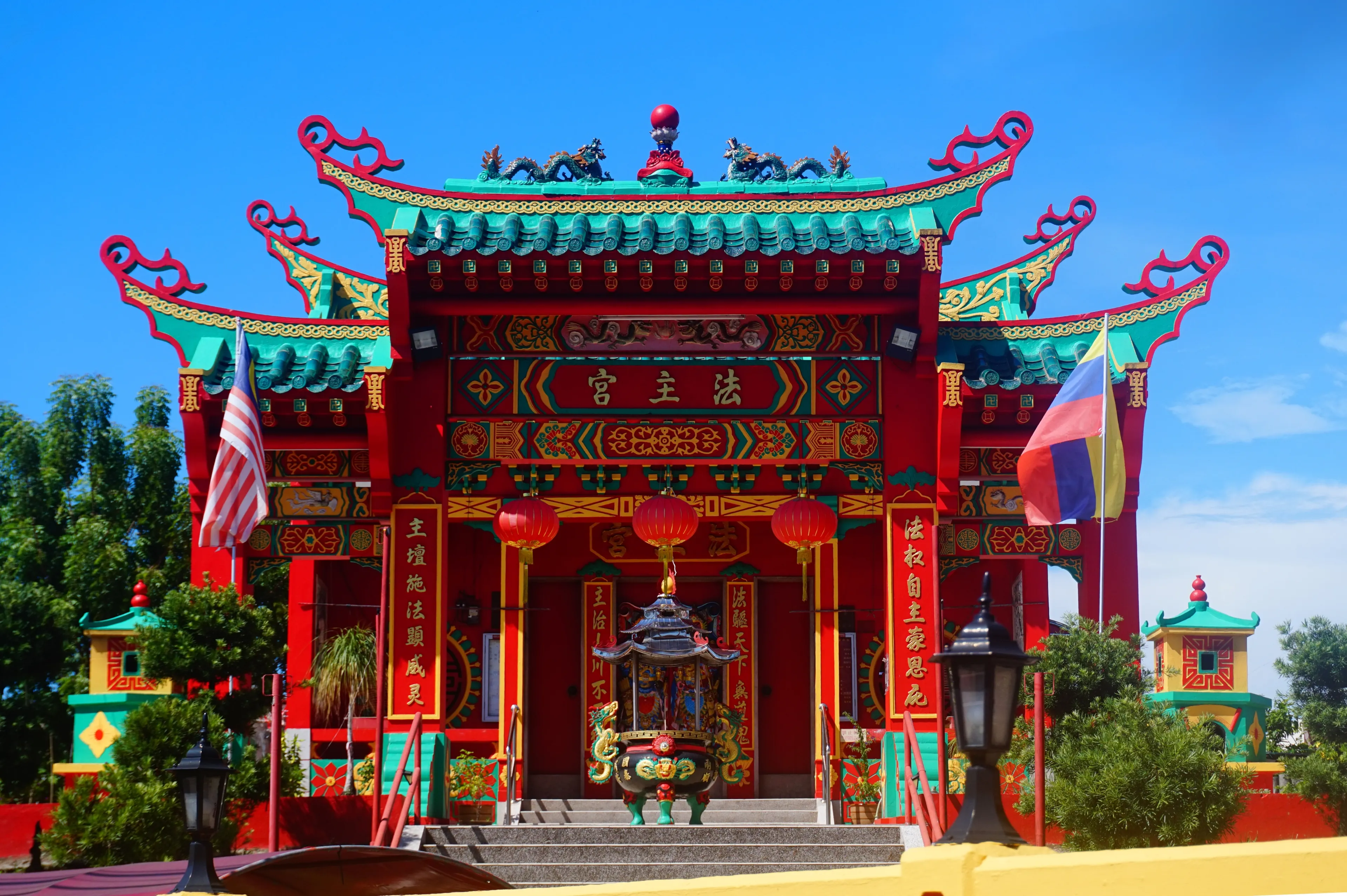 Labuan, Malaysia - April 23, 2024: The front entrance of the Huat Choo Kung Temple is located at Jalan Tun Mustapha Labuan Malaysia. A Red temple named Huat Choo Kung in Malaysia territory. 