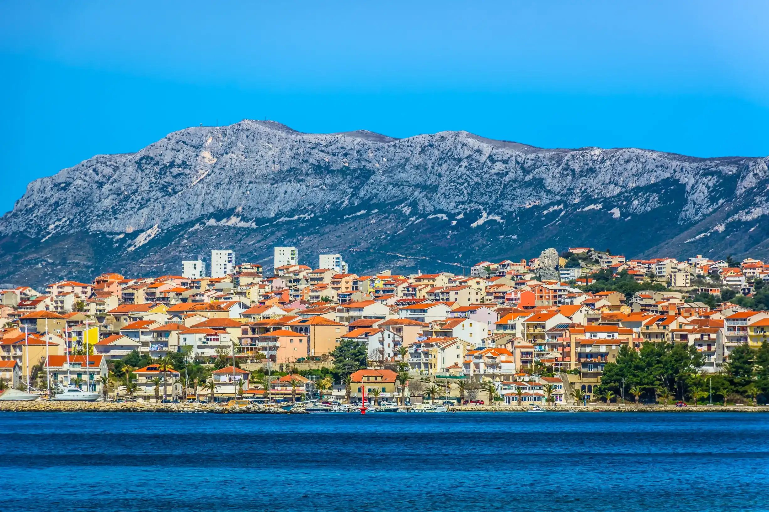 Seafront view at picturesque small town Podstrana in suburb of Split city, Croatia Mediterranean. / Selective focus. Seafront view at picturesque small town Podstrana in suburb of Split city, Croatia Mediterranean. / Selective focus.