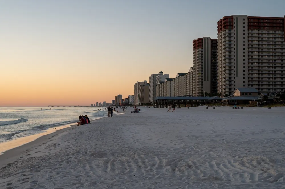 Panama City Beach, Florida - November 3, 2023 - Beach and beachfront residential buildings in evening twilight on cloudless autumn afternoon.