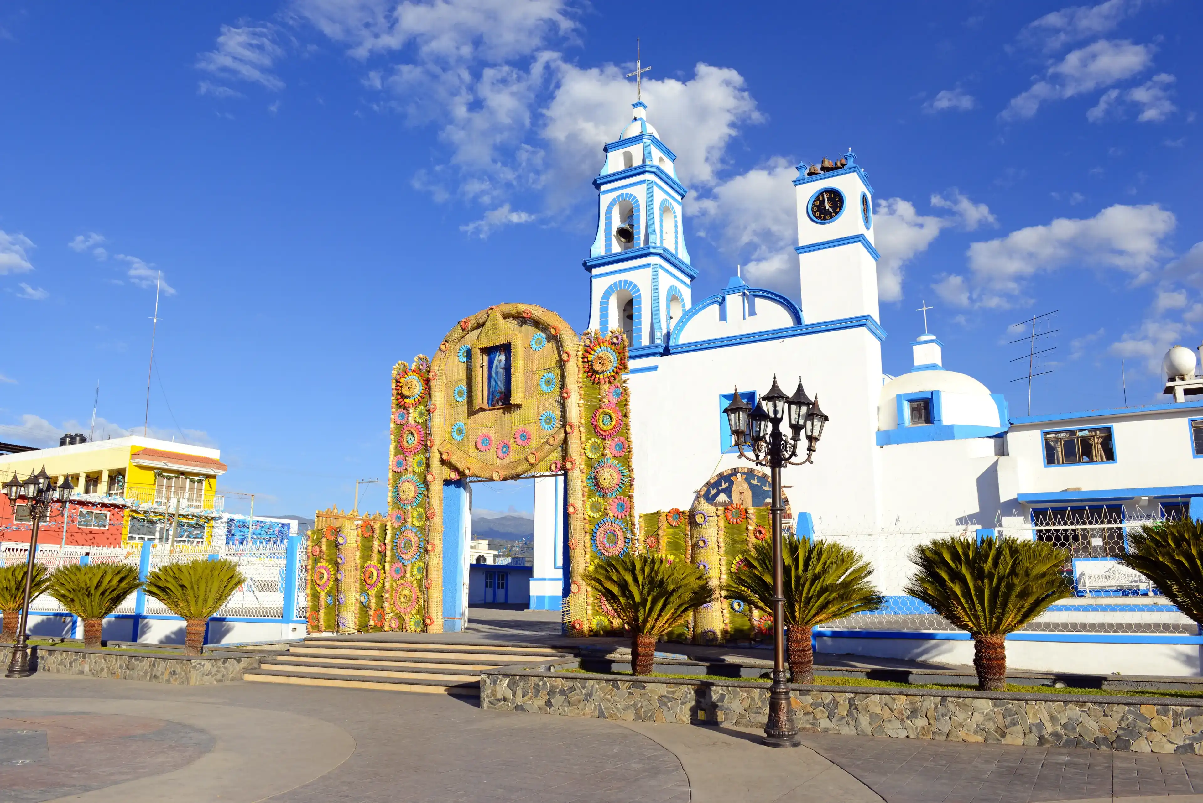 Colorful Church with blue sky background located near borders of Veracruz and Puebla, close to Pico de Orizaba, Iztaccihuatland Popocatepetl volcanoes, Mexico Colorful Church with blue sky background located near borders of Veracruz and Puebla, close to Pico de Orizaba, Iztaccihuatland Popocatepetl volcanoes, Mexico