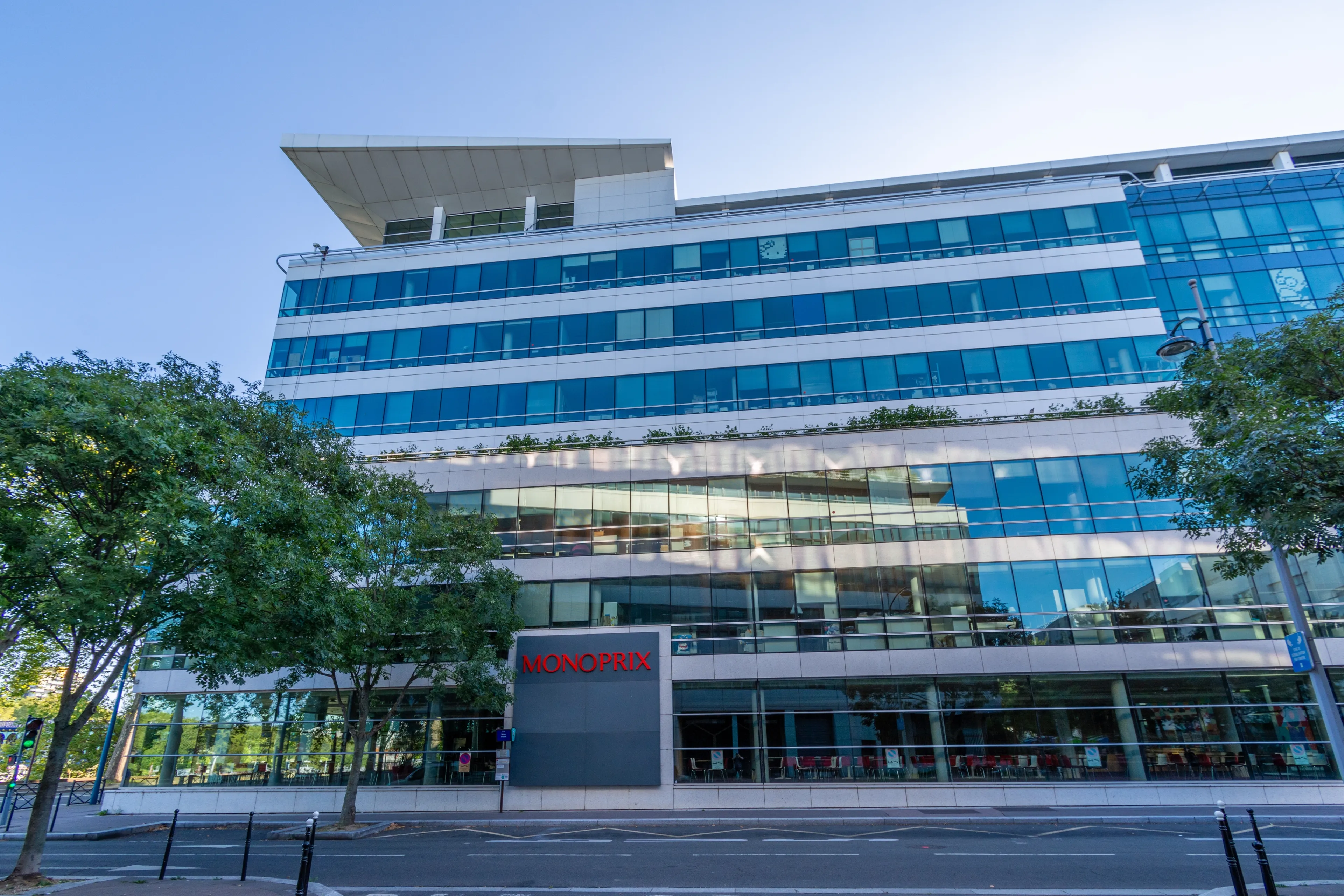 Clichy, France - August 20, 2023: Facade of the building housing the headquarters of the French company Monoprix. The Monoprix stores retail food as well as fashion, beauty and home products
