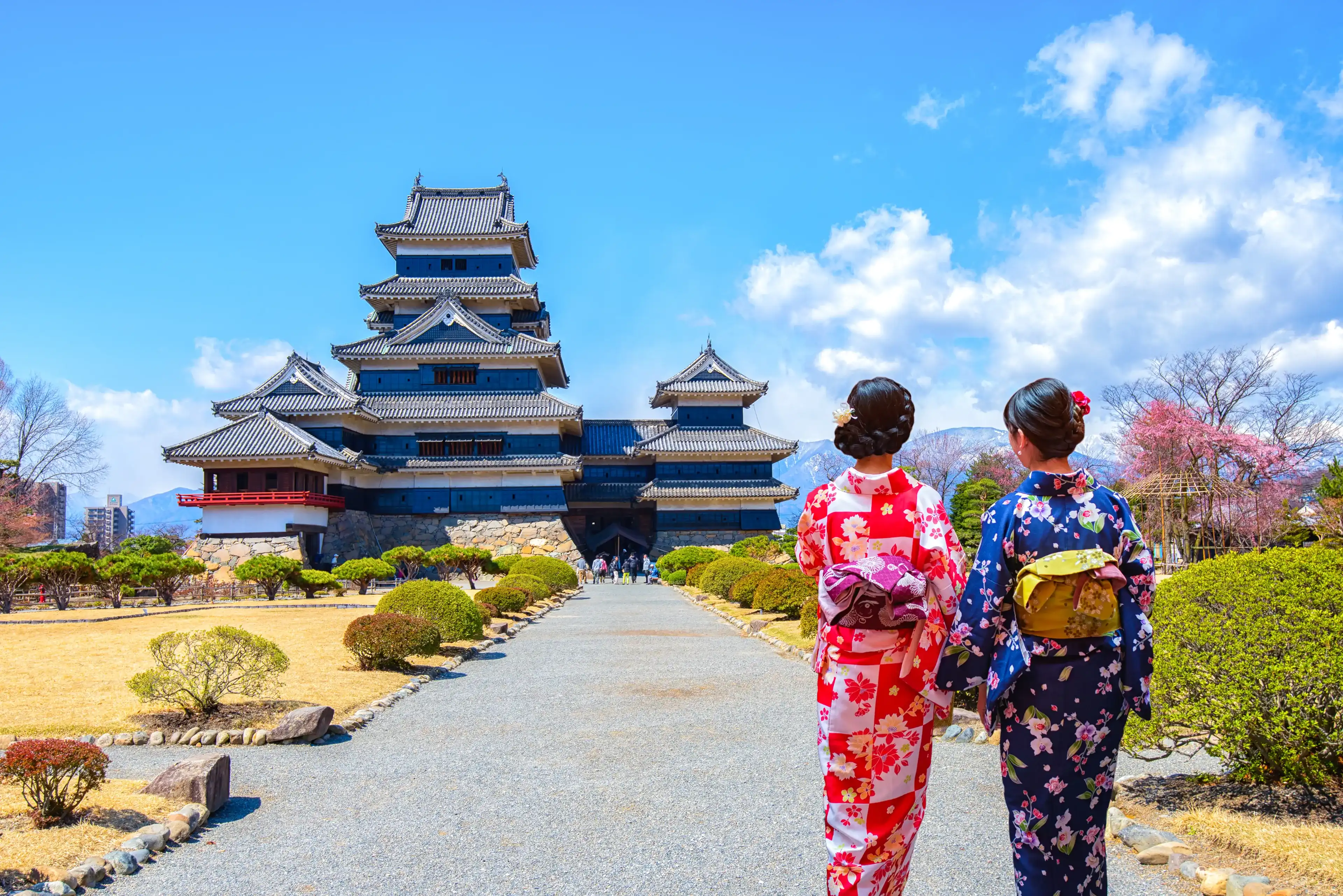 Two geishas wearing traditional japanese kimono among Matsumoto Castle is one of the most complete and beautiful among Japan's original castles.