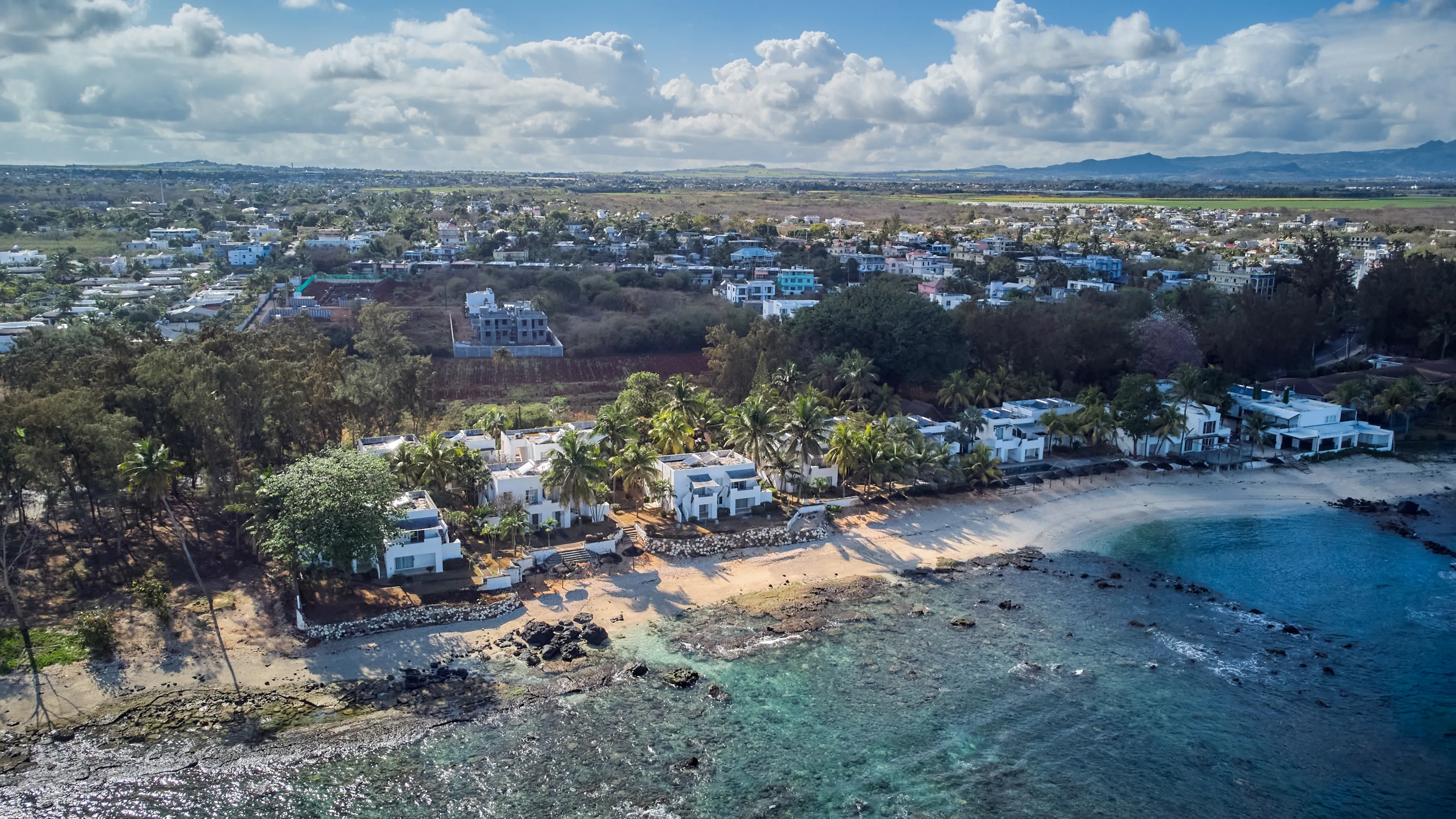 Aerial view in Mauritius over Pointe aux Piments beach, a beautiful tropical beach in the Indian Ocean