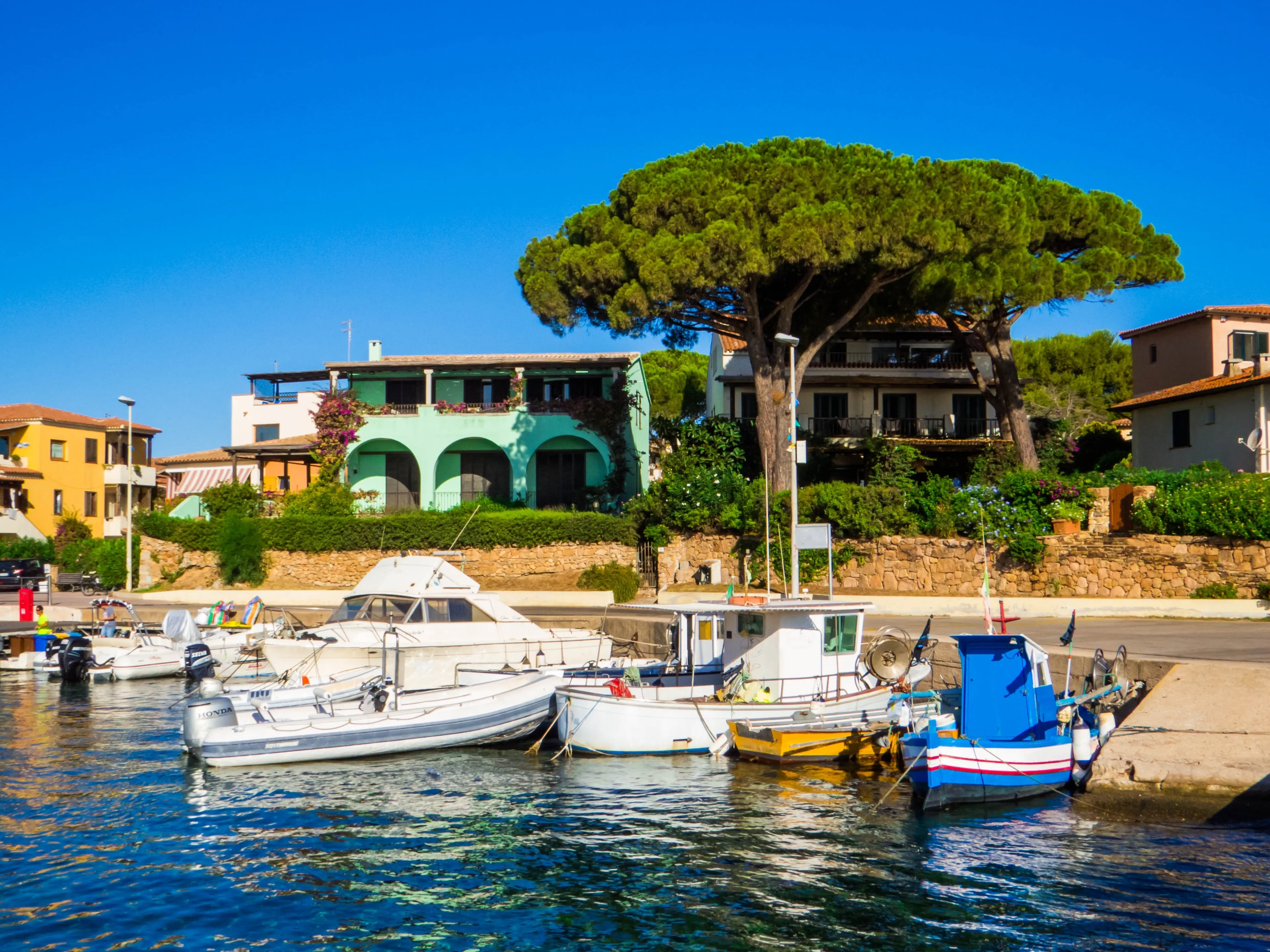 Budoni, Italy - August 8. 2023: Boats in the harbor of Porto San Pietro.