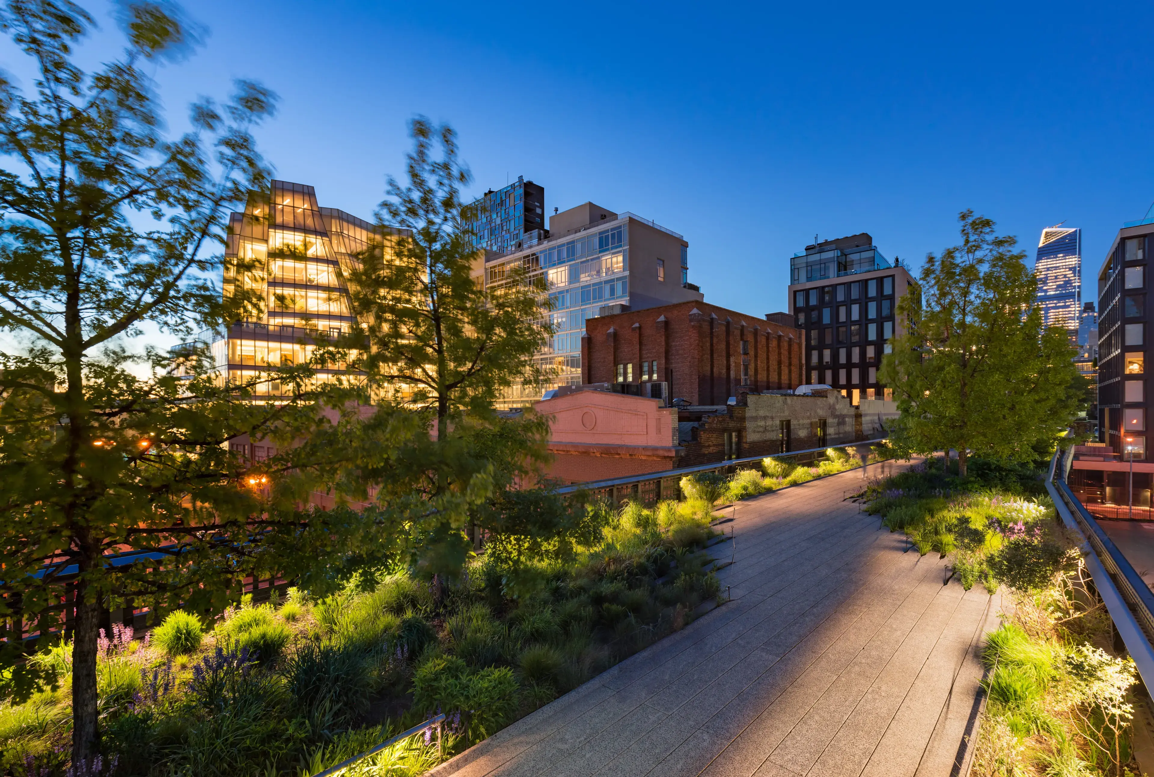 The Highline (High Line Park aerial green-way) at twilight in summer. Chelsea, Manhattan, New York City The Highline (High Line Park aerial green-way) at twilight in summer. Chelsea, Manhattan, New York City