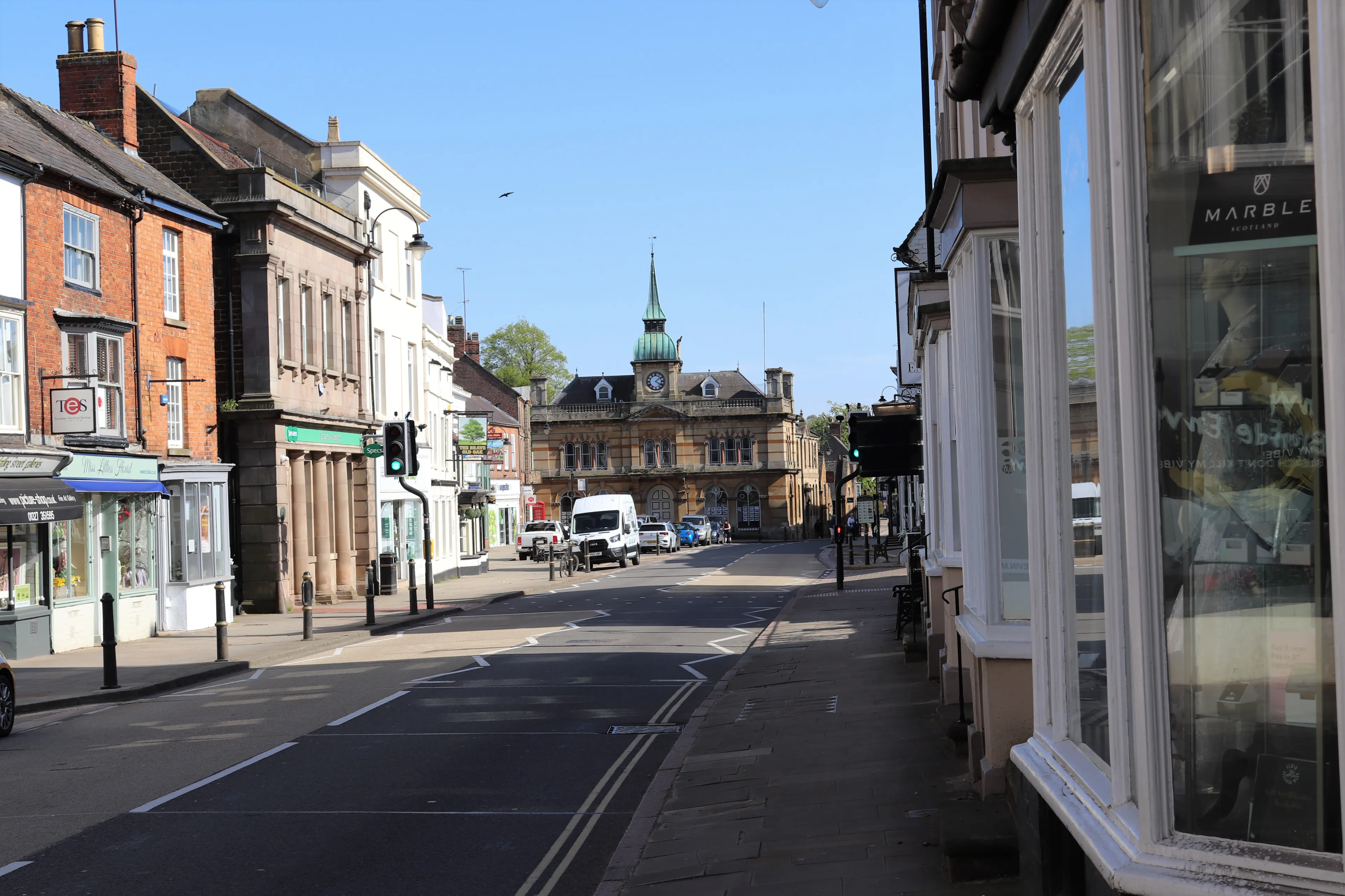 Towcester, Northamptonshire, England - April 21st 2020: Deserted High Street at Towcester during the Covid-19 lockdown of 2020. Empty road and shops at popular market town, deserted during lockdown.