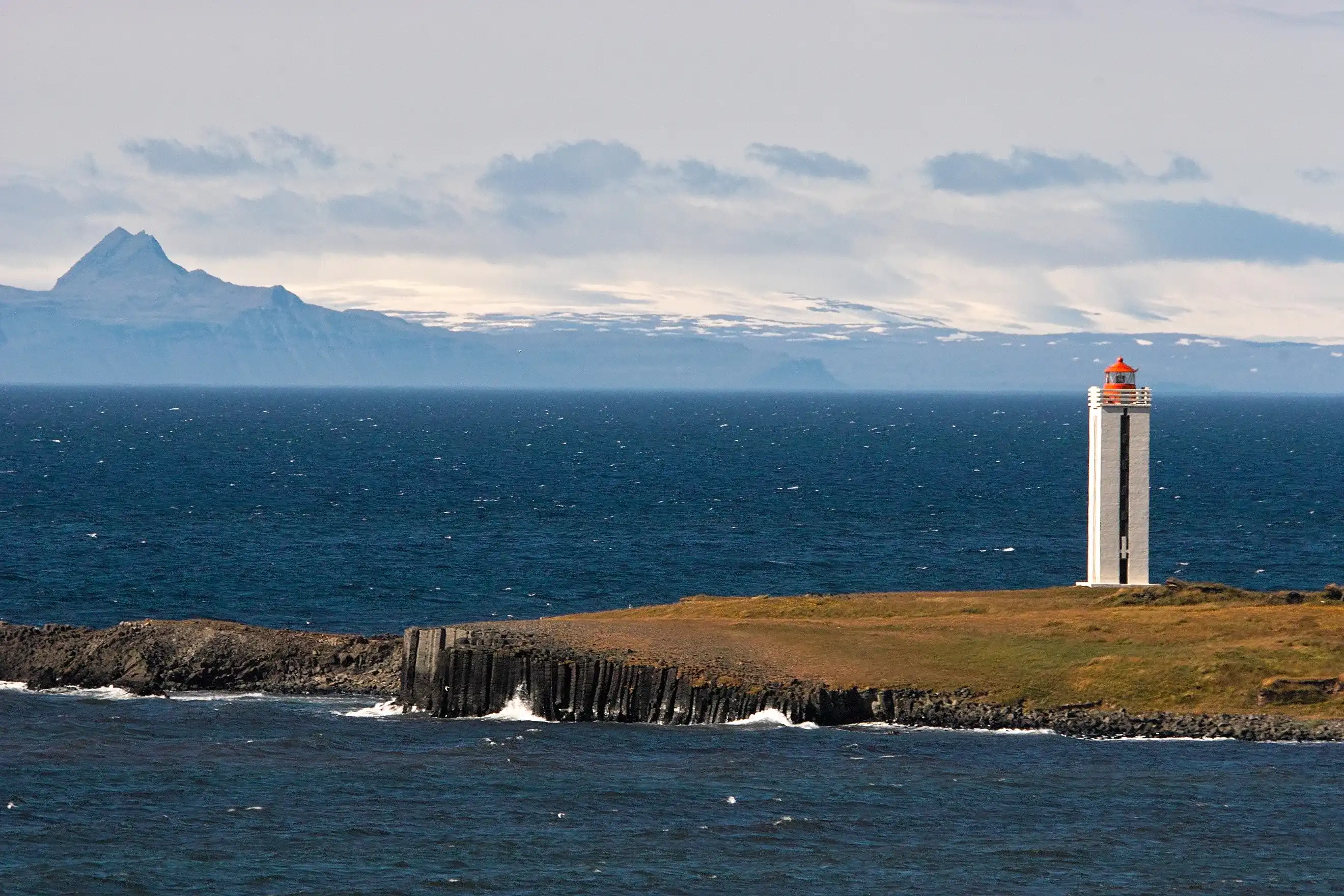 Kálfshamarsviti lighhouse with Vestfirðir behind the sea