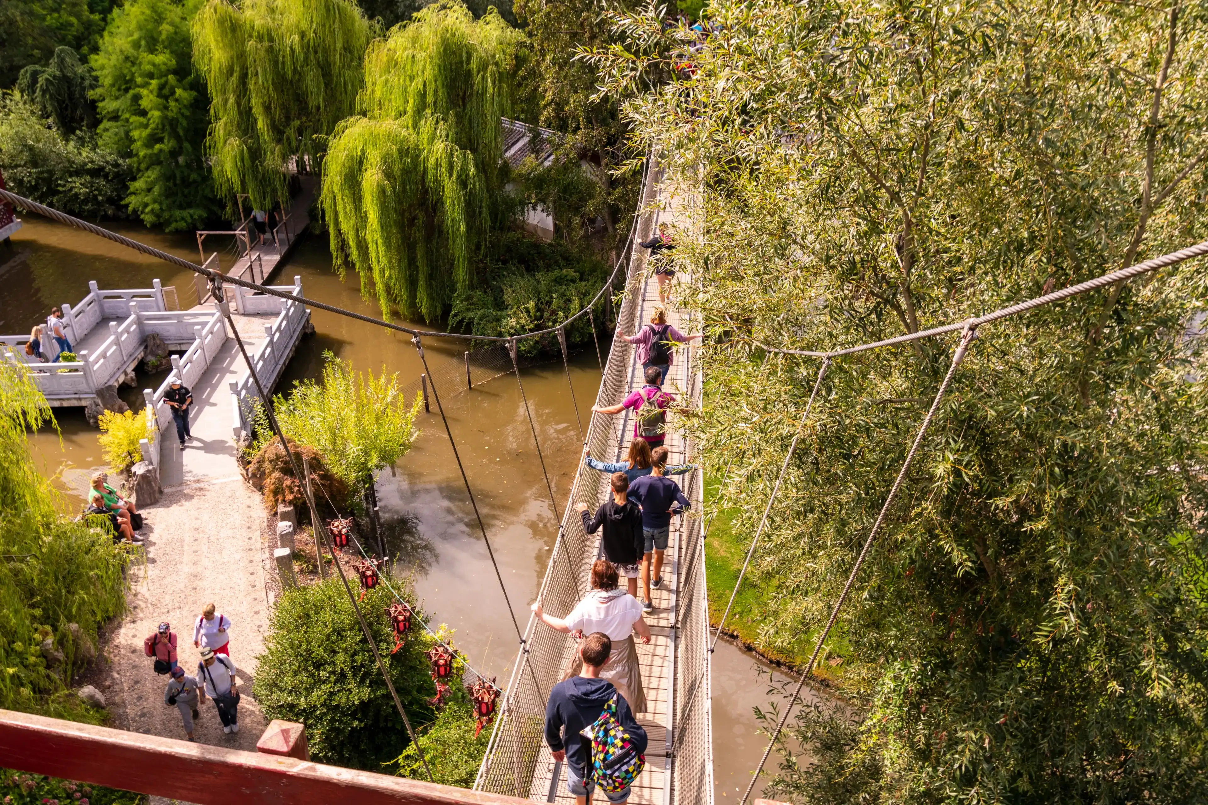 Bruggelette, Belgium - August 23, 2018: Theme Park Pairi Daiza. People walking across the hanging bridge