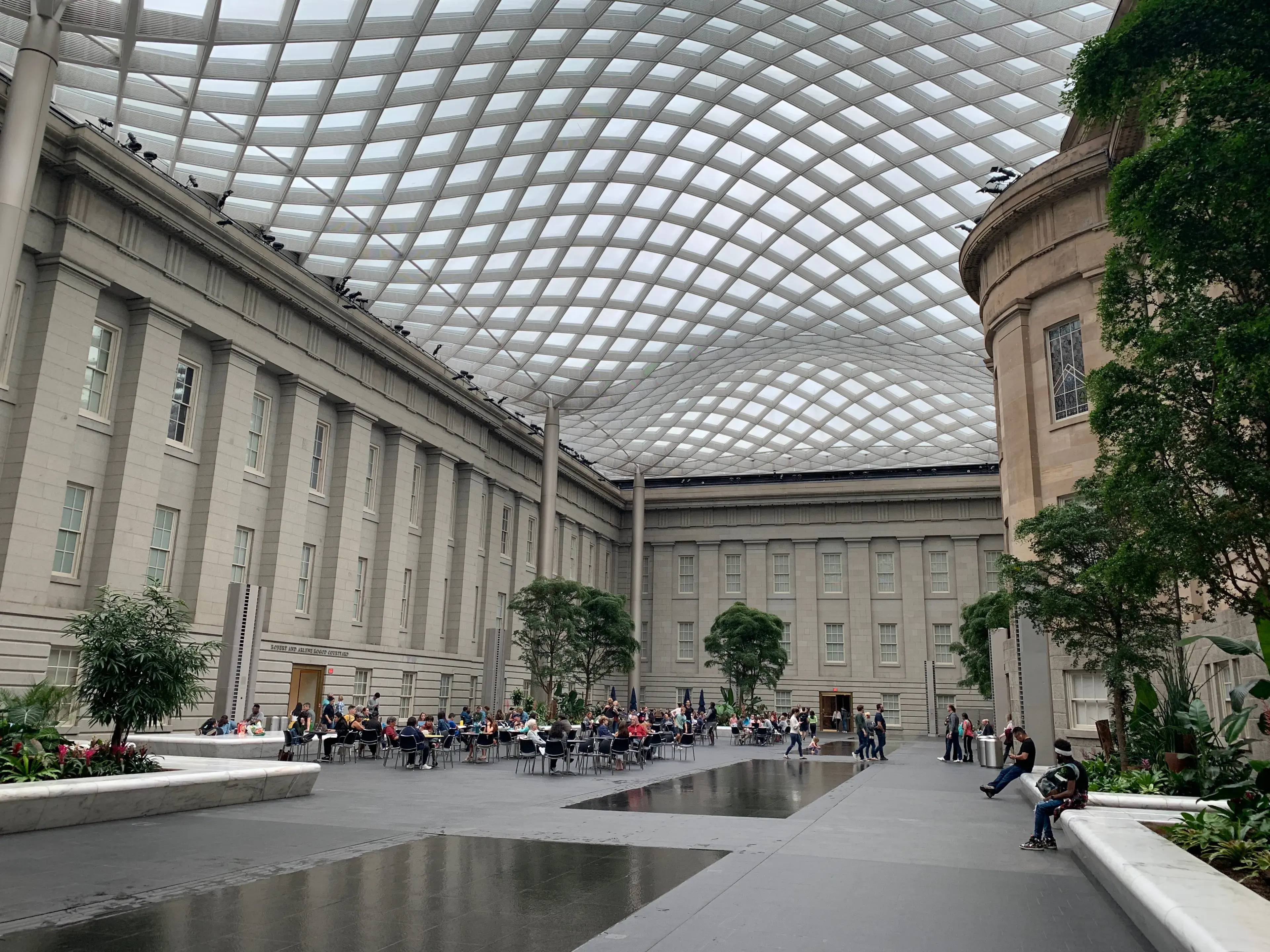 Washington, District of Columbia / US - October 12, 2019: Interior skylight public court yard of the Smithsonian National Portrait Gallery free wifi DC museum cafe people table seated stone building Washington, District of Columbia / US - October 12, 2019: Interior skylight public court yard of the Smithsonian National Portrait Gallery free wifi DC museum cafe people table seated stone building