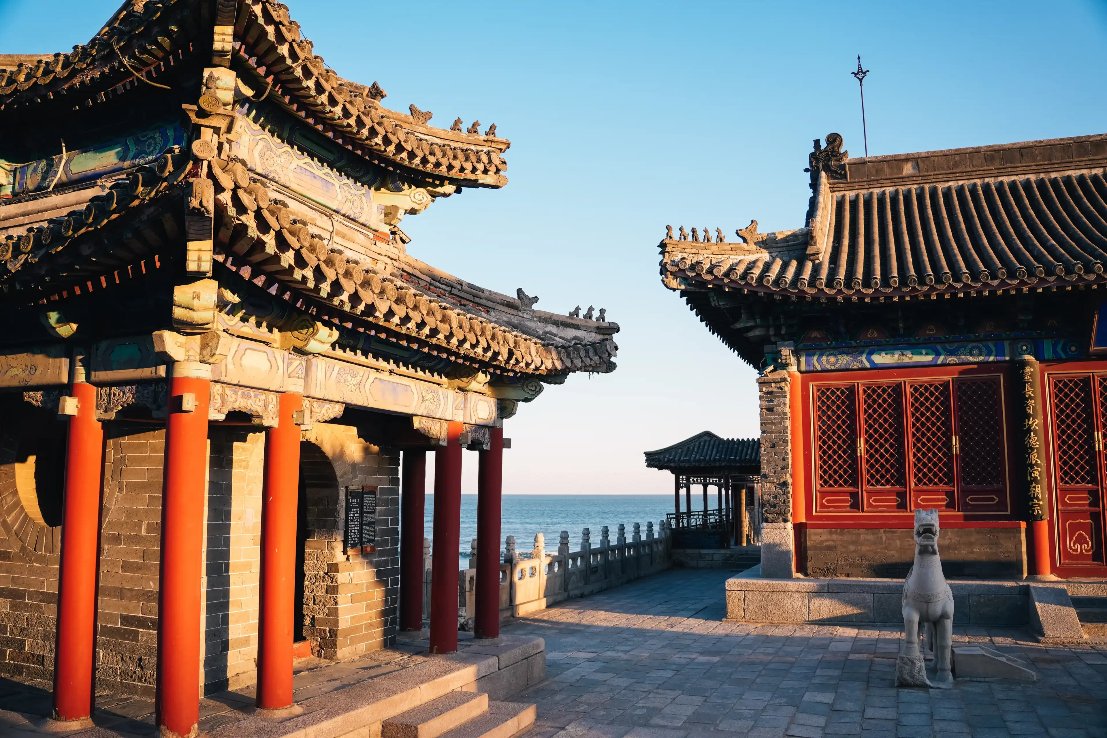 Buddhist temple on the beach with the sea in the background on a sunny day at sunset, Qinhuangdao, China Buddhist temple on the beach with the sea in the background on a sunny day at sunset, Qinhuangdao, China