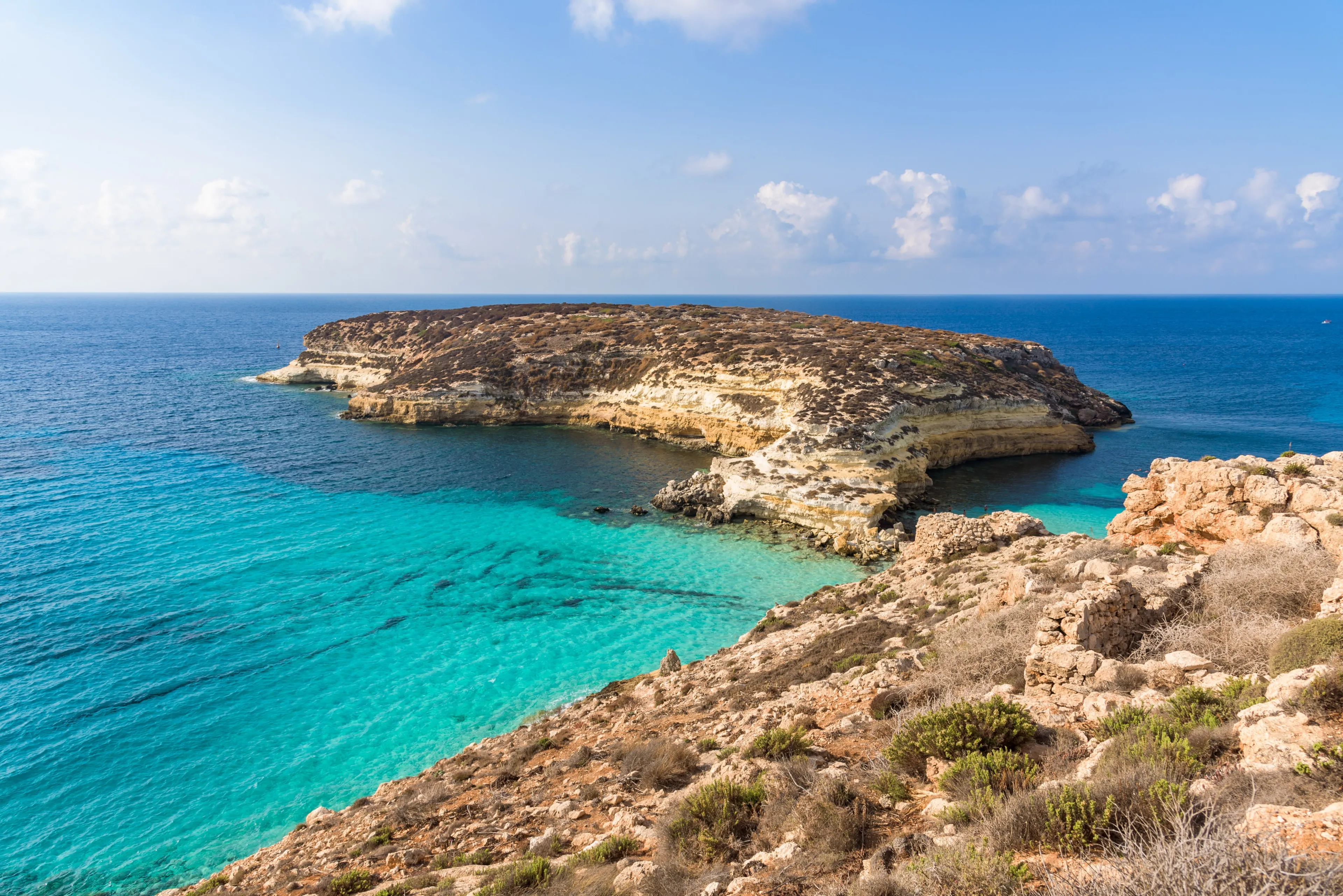 Isola dei Conigli (Rabbit Island) and its beautiful beach with turquoise sea water. Lampedusa, Sicily, Italy.
