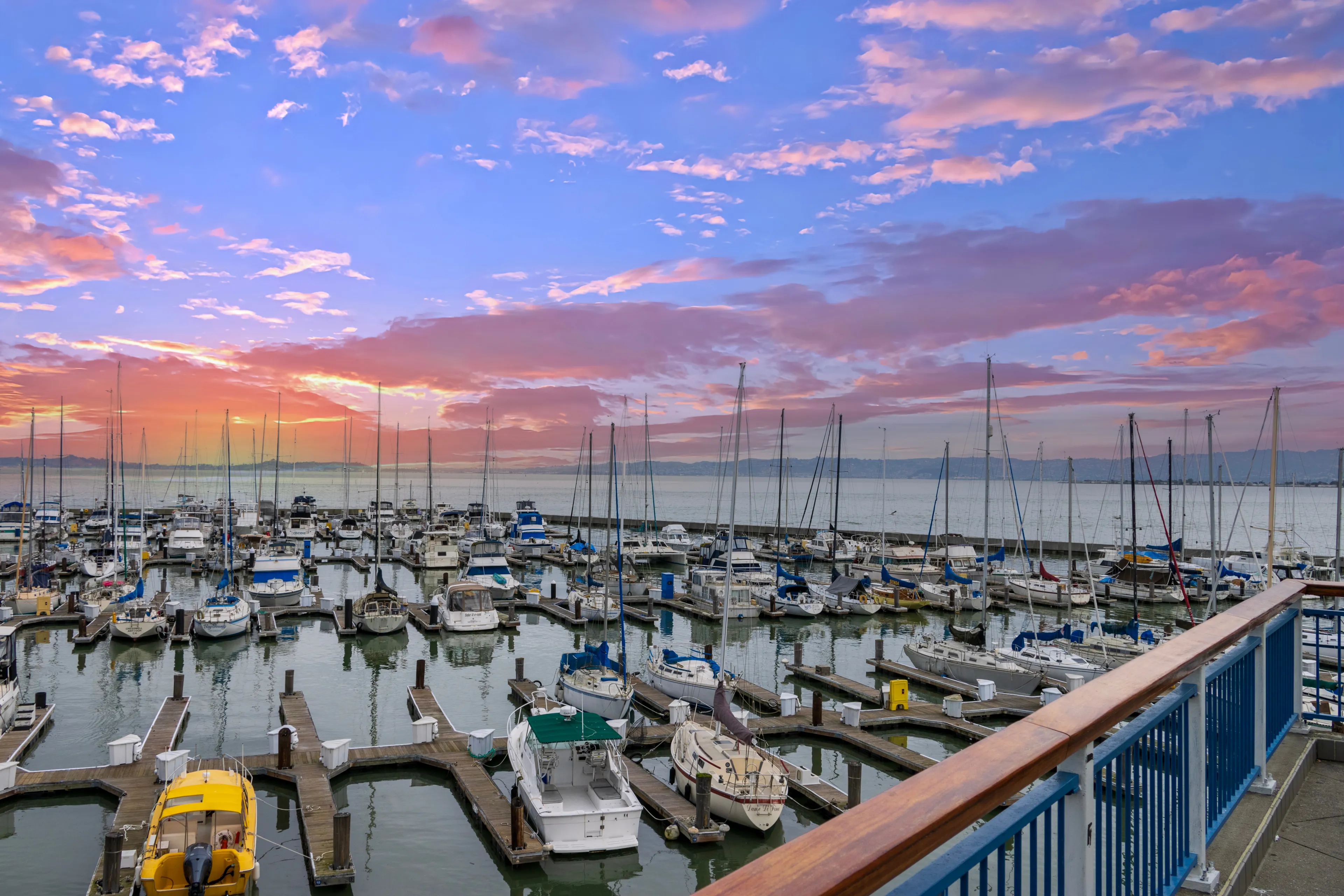 San Francisco California USA - 1 24 2024: a beautiful spring landscape at Fisherman's Wharf on Pier 39 with boats and yachts docked in the harbor with ocean water at sunset in San Francisco California