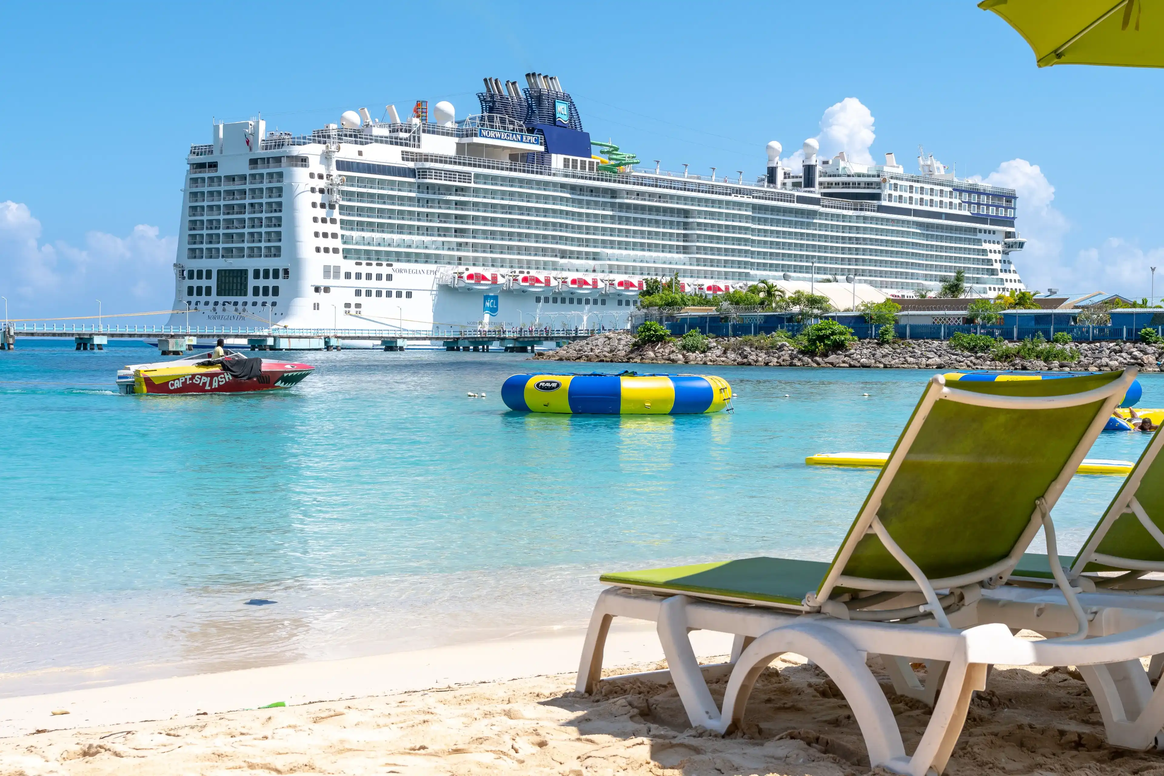 Ocho Rios, Jamaica - April 23 2019: View from tropical white sand beach of Norwegian (NCL) Epic Cruise Ship docked at the Ocho Rios Cruise Port Terminal in Saint Ann, Jamaica