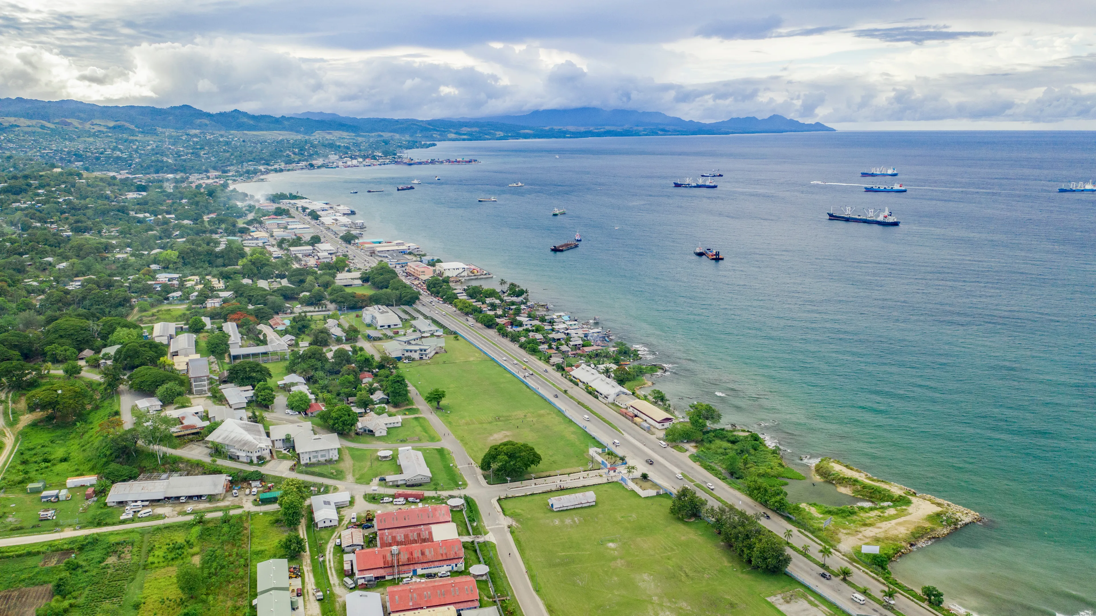 Ships and boats anchored out in Honiara's harbour and port.