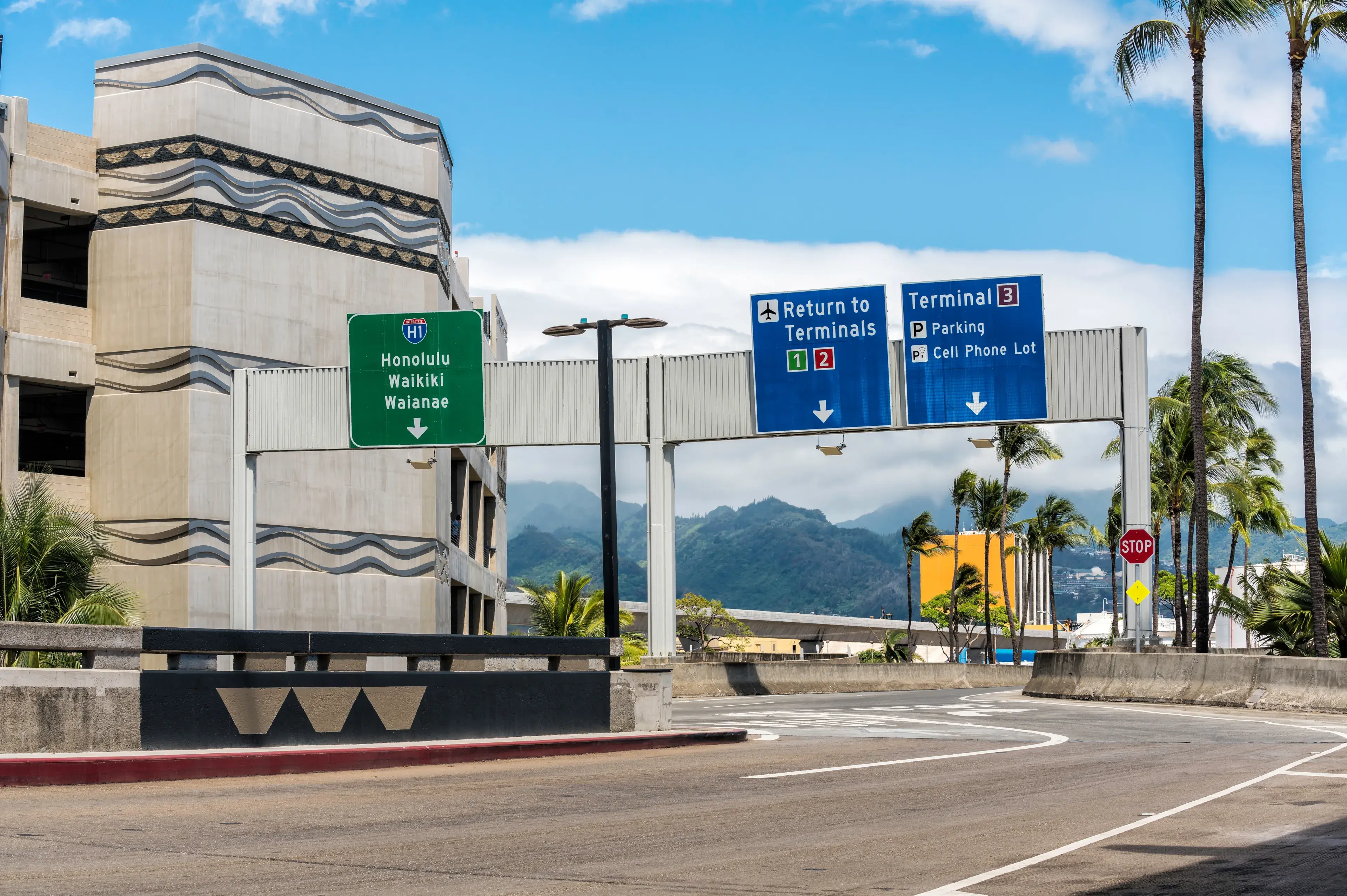 Road signs above the road on International Airport in Honolulu, Hawaii Road signs above the road on International Airport in Honolulu, Hawaii