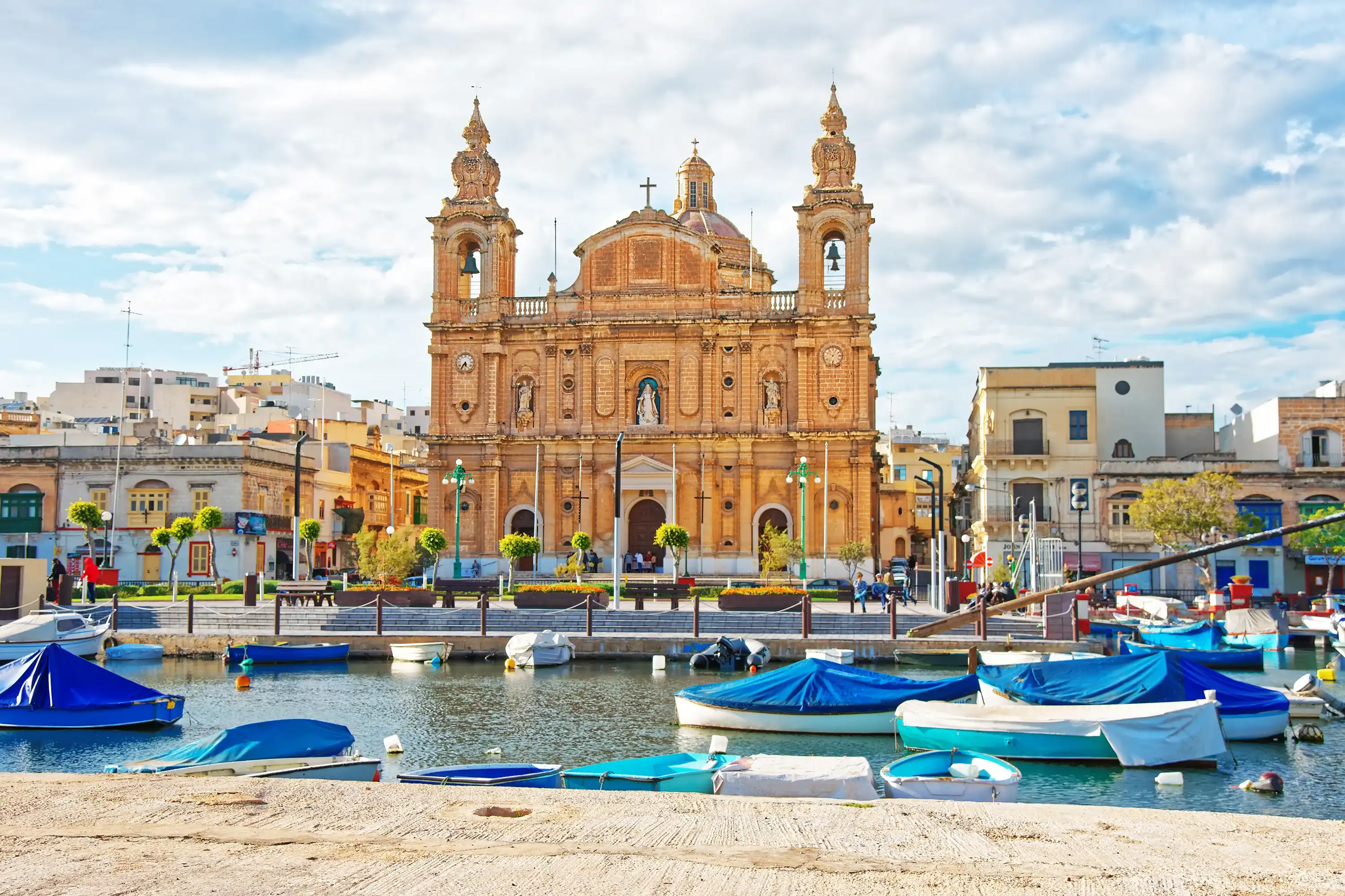Parish Church at Msida marina with boats on Malta Island. People on the background