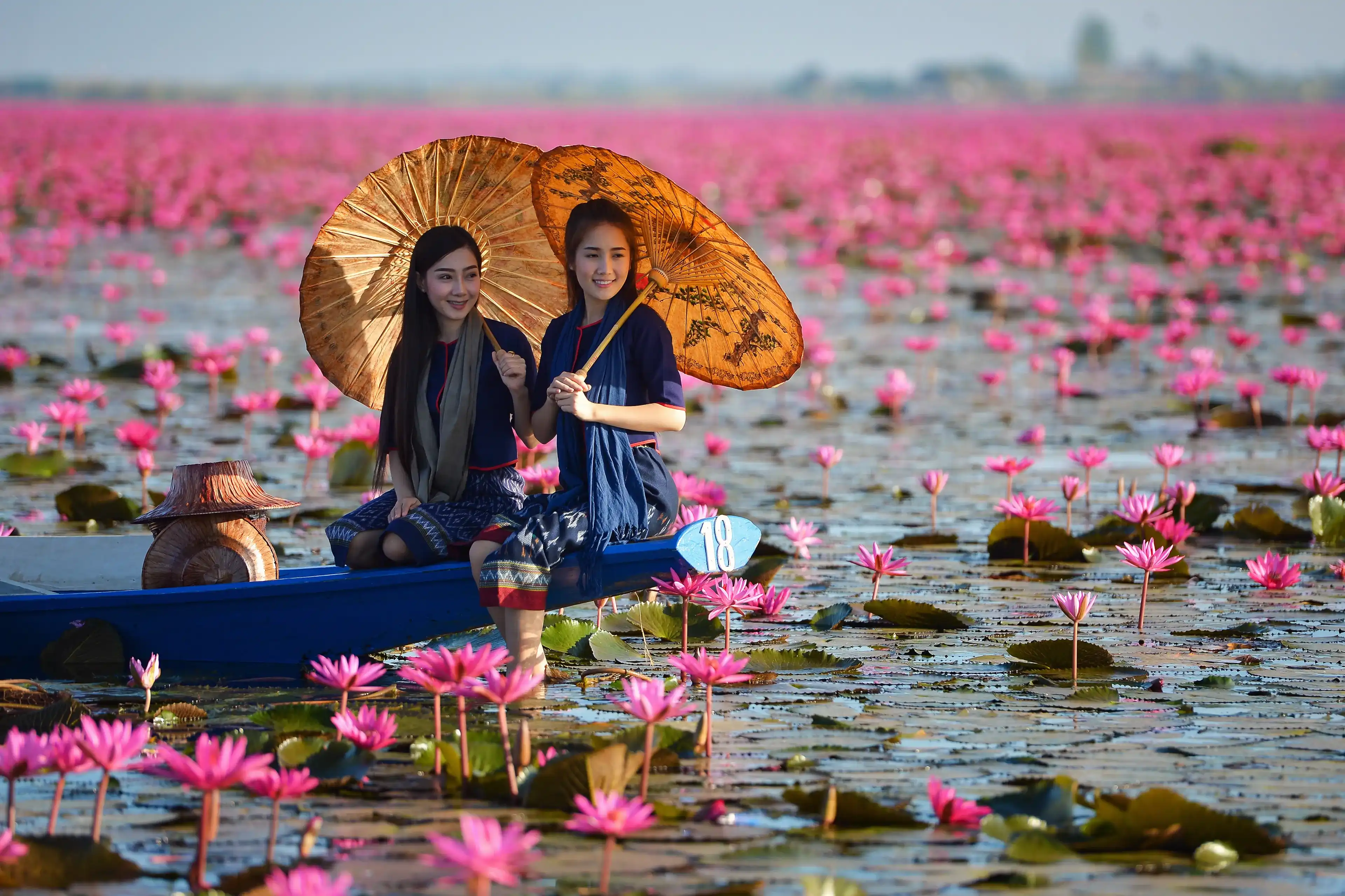 Laos woman in flower lotus lake, Woman wearing traditional Thai people , Red Lotus Sea UdonThani Thailand