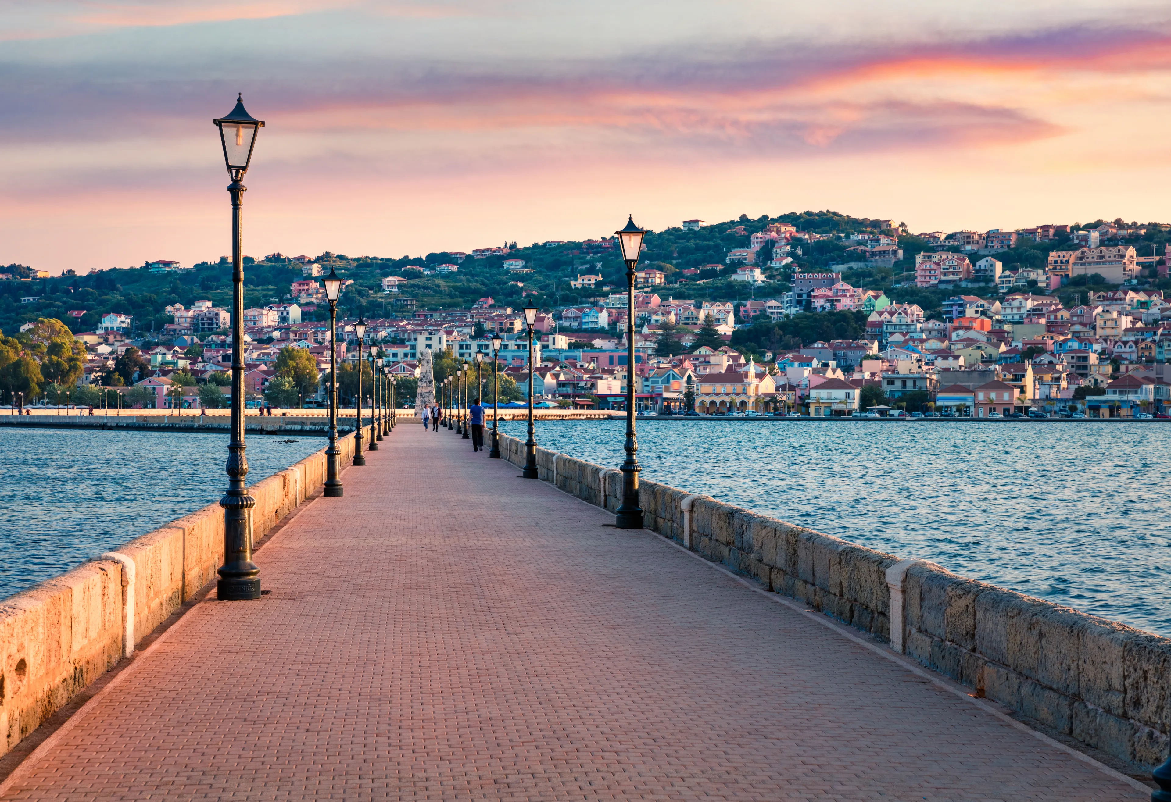 Stunning evening cityscape of Argostolion town, former municipality on the island of Kefalonia, Ionian Islands, Greece. Wonderful spring seascape of Ionian Sea. Traveling concept background.