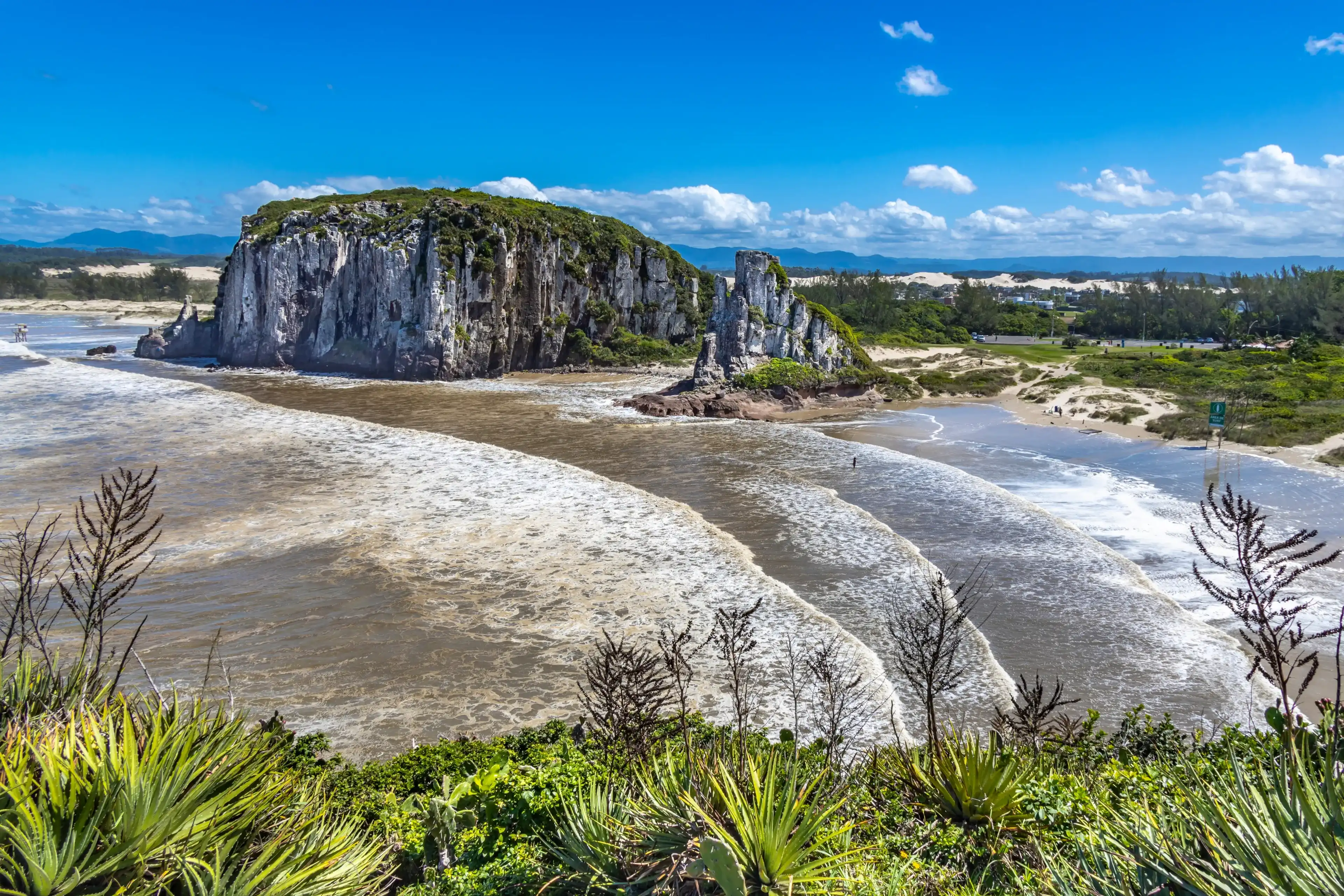 TORRES, BRAZIL - CIRCA MARCH, 2022: Praia da Guarita seen from Torre do Meio, a rock formation in Guarita Park, a tourist attraction in the city of Torres, in the state of Rio Grande do Sul TORRES, BRAZIL - CIRCA MARCH, 2022: Praia da Guarita seen from Torre do Meio, a rock formation in Guarita Park, a tourist attraction in the city of Torres, in the state of Rio Grande do Sul