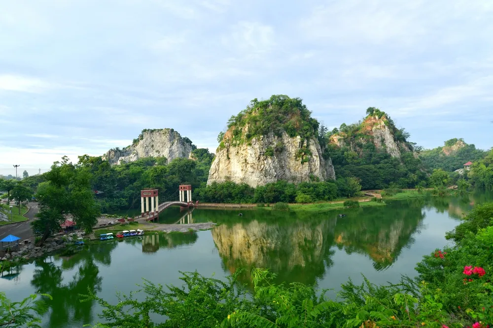 Ratchaburi, Thailand - September 13, 2024: Limestone mountains with waterways and a relaxing atmosphere. In the area there are suspension bridges, pedal boats and pushcarts selling things.