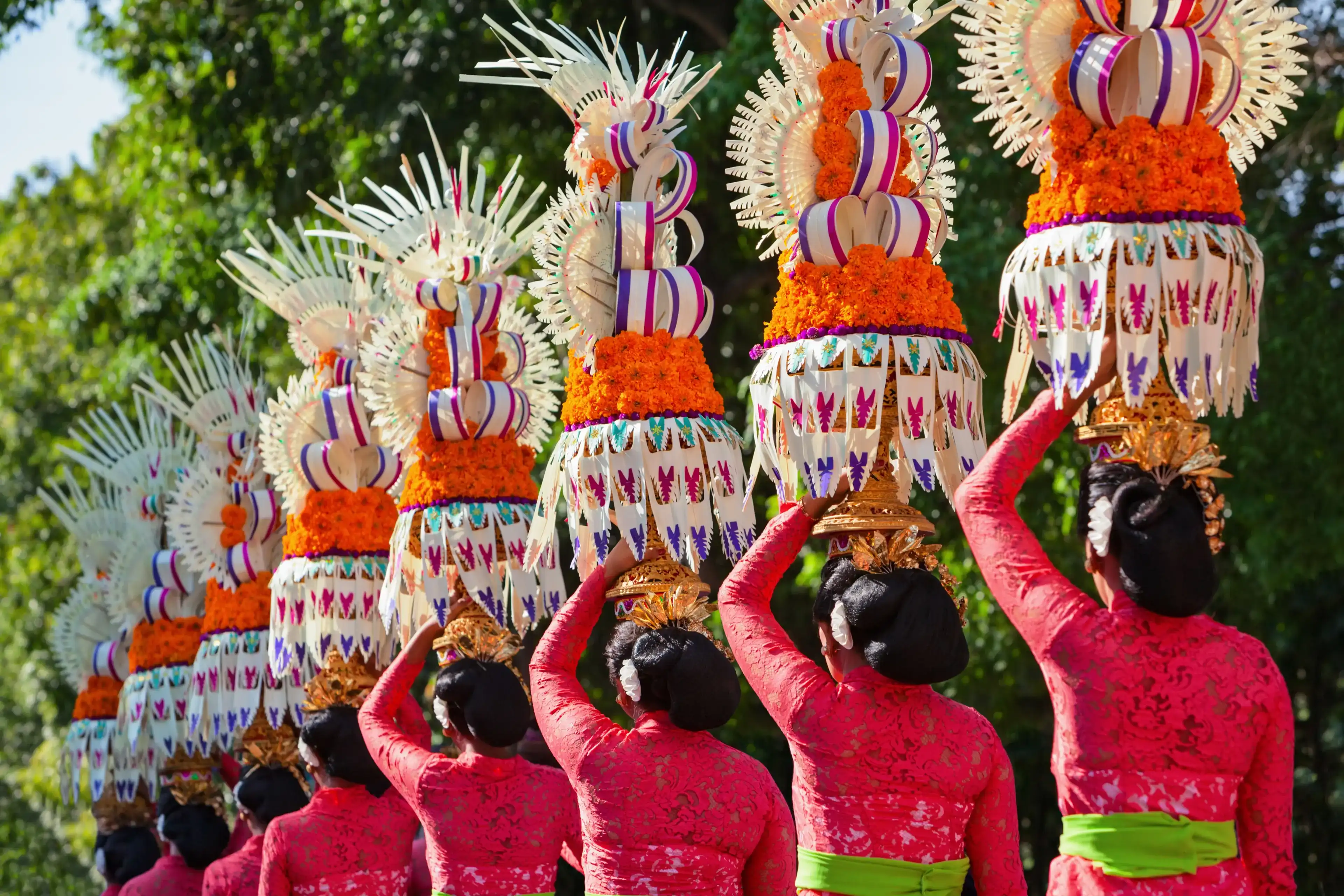 Group of beautiful Balinese women in costumes - sarong, carry offering for Hindu ceremony. Traditional dances, arts festivals, culture of Bali island and Indonesia people. Indonesian travel background Group of beautiful Balinese women in costumes - sarong, carry offering for Hindu ceremony. Traditional dances, arts festivals, culture of Bali island and Indonesia people. Indonesian travel background