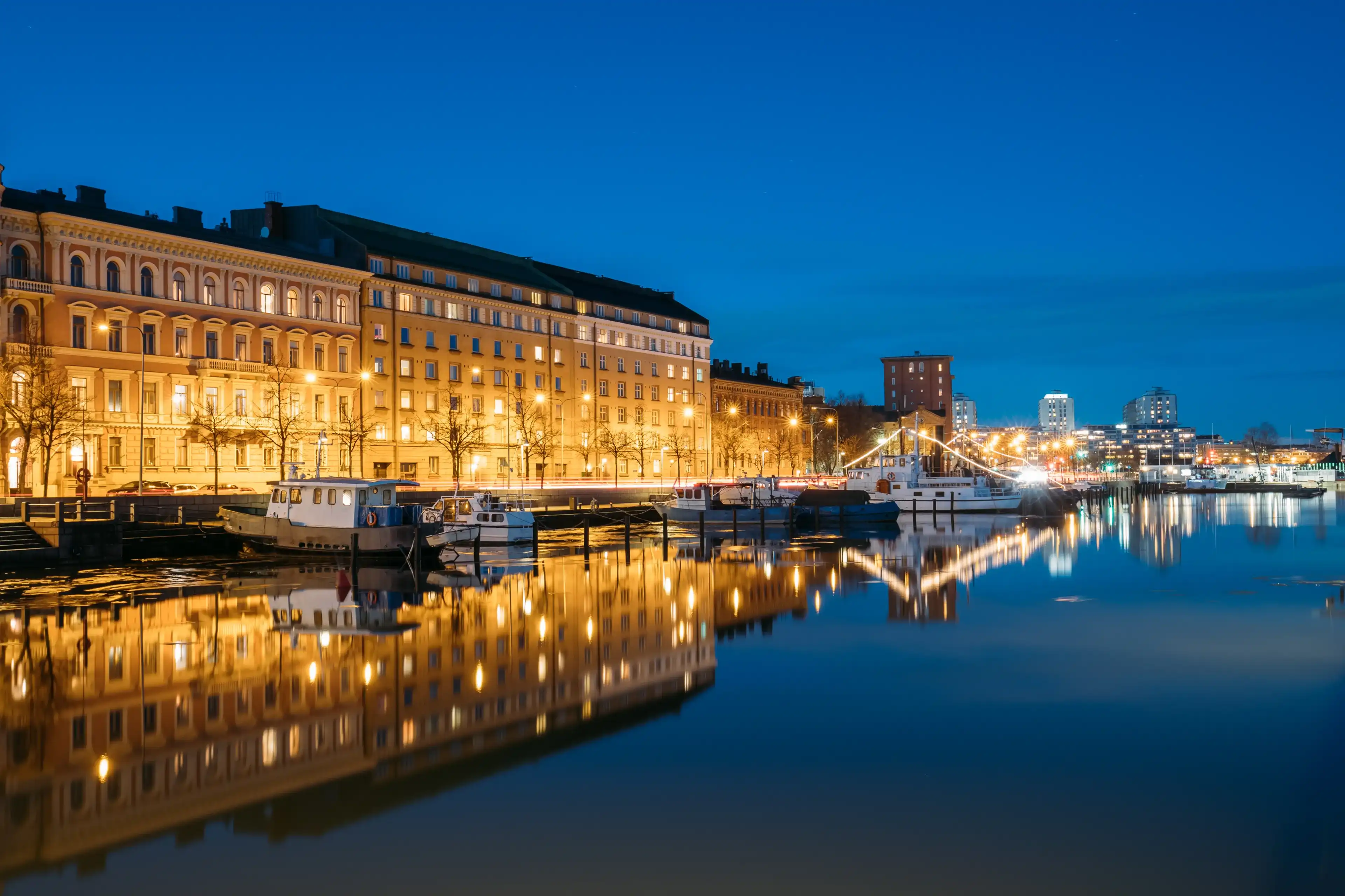 Helsinki, Finland. View Of Pier With Boats And Pohjoisranta Street In Evening Night Illuminations.