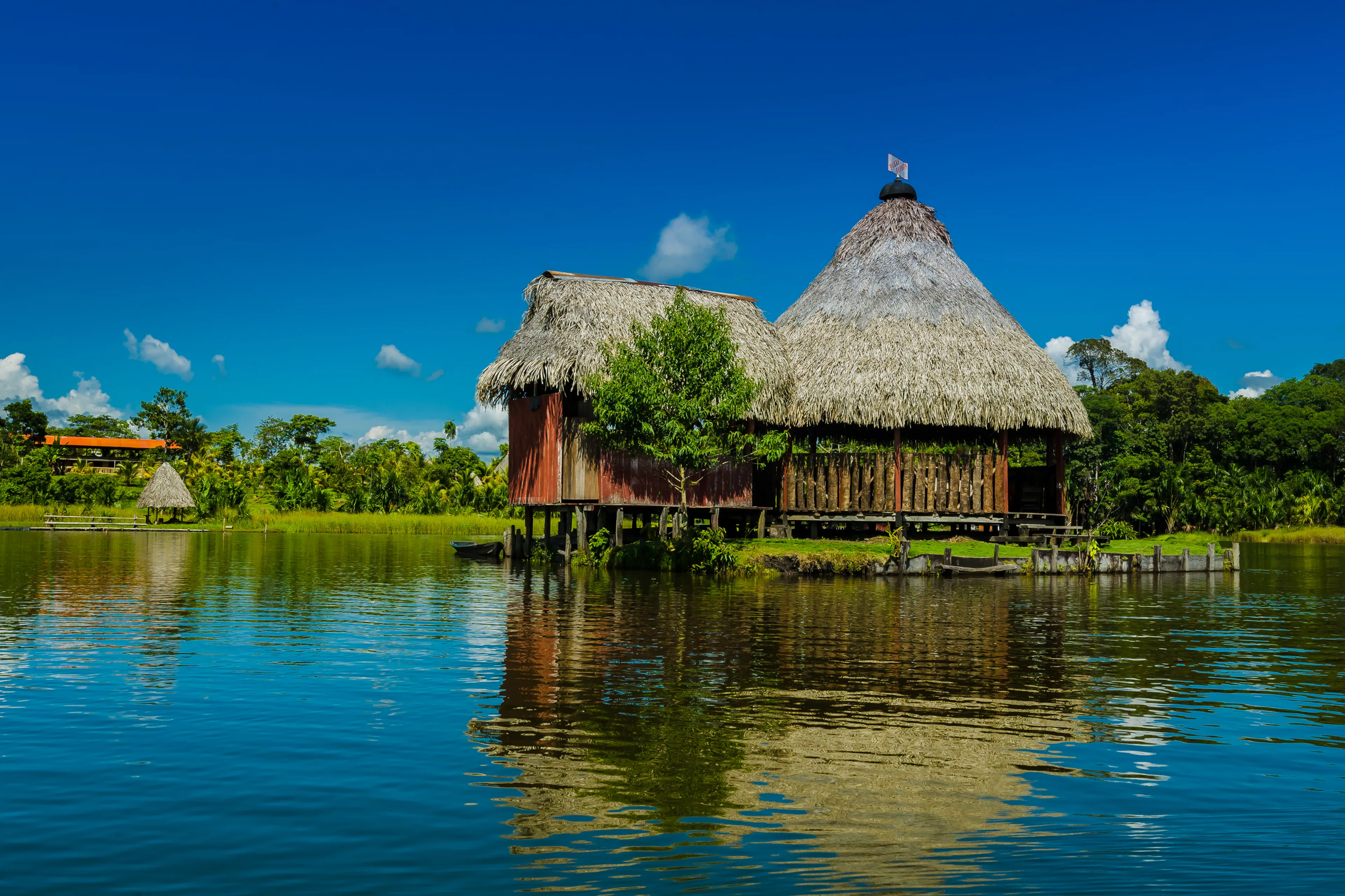 Wooden and straw house built on the lake in the Peruvian jungle