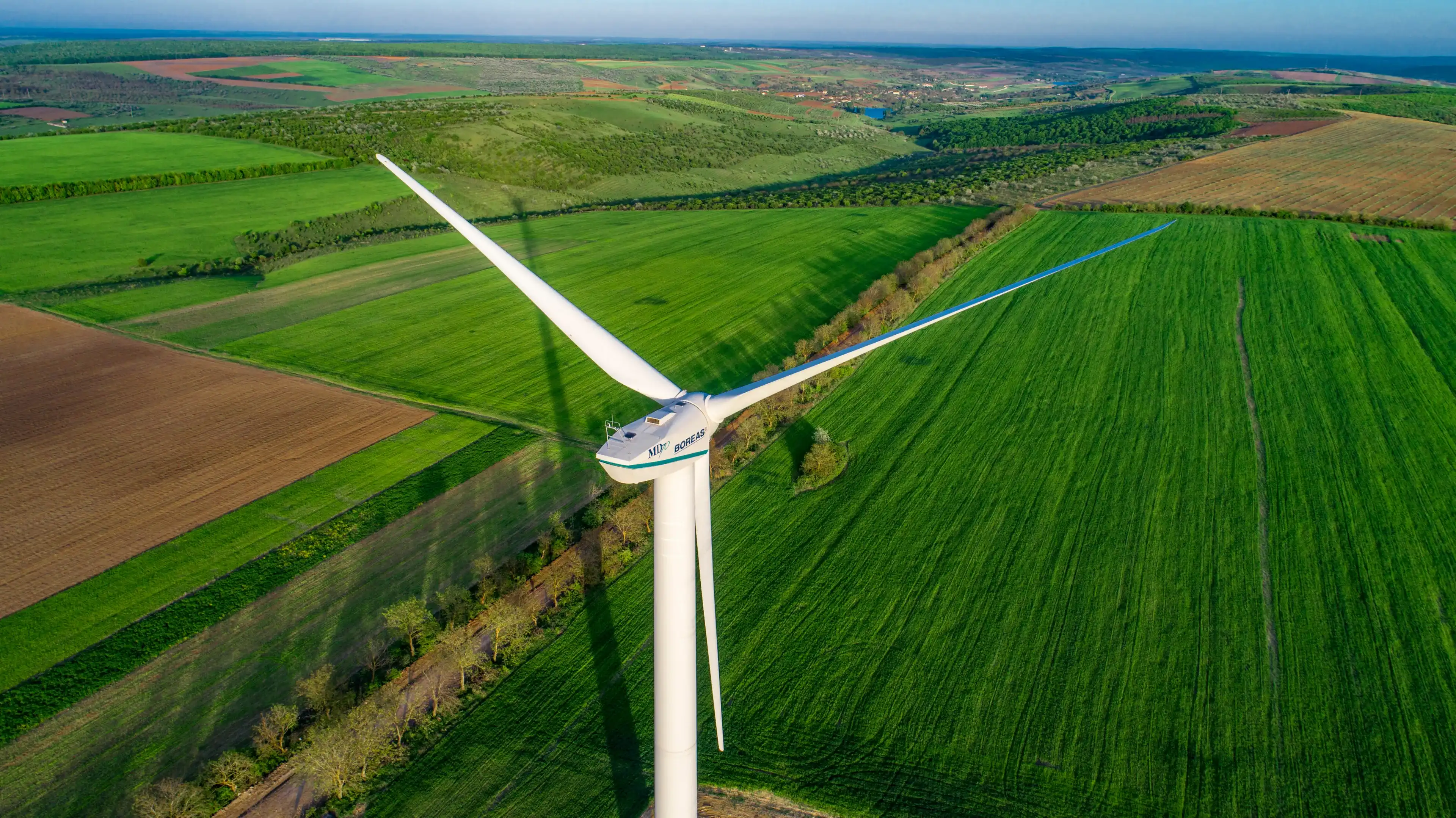 Busauca, Rezina / Moldova - april 30 2018: Boreas MD 70 wind turbine in green fields shot with a drone 