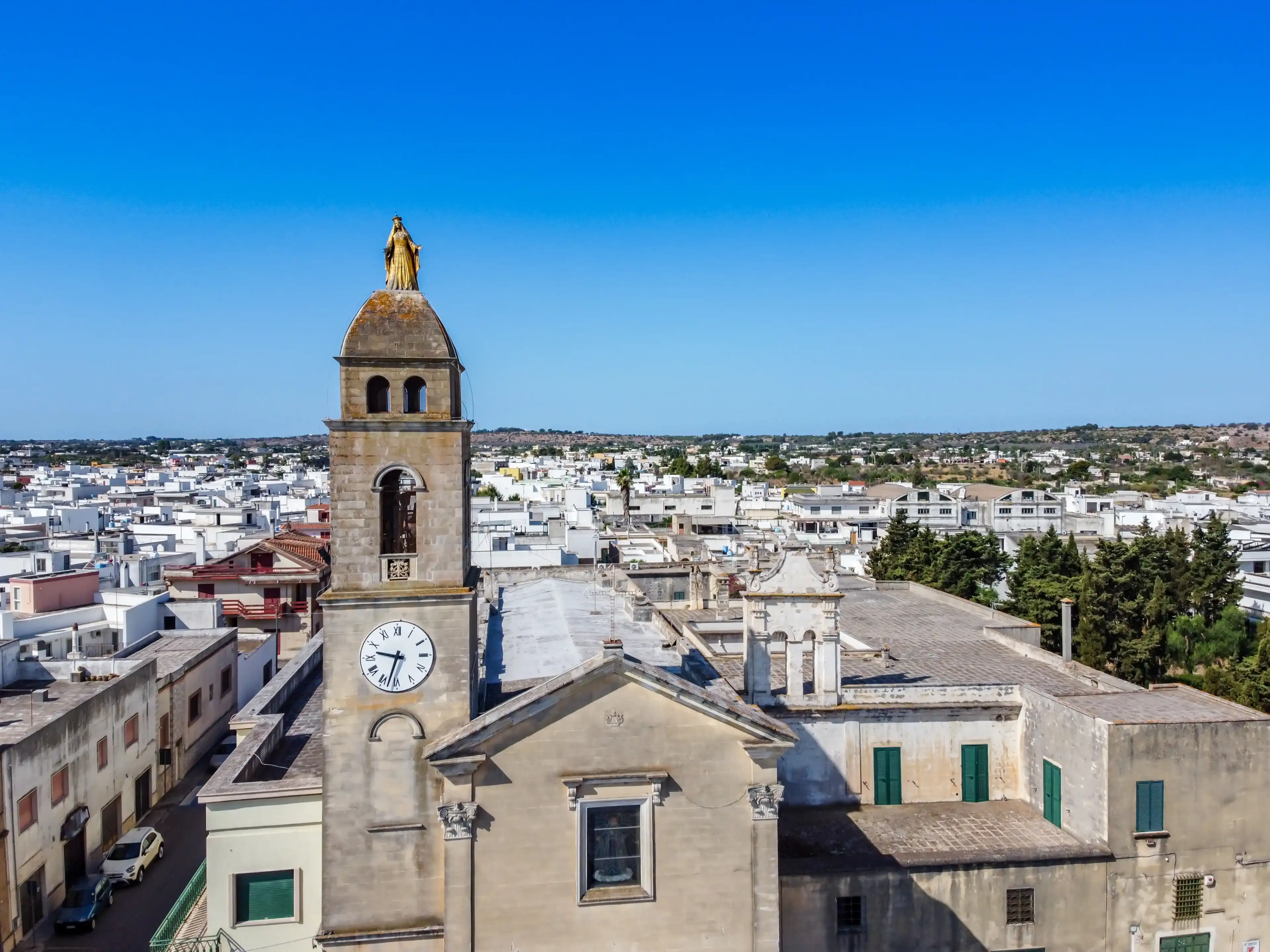 Close Up on the Madonna Golden Statue on the Belltower of the Santuario of Maria Addolorata shooted by Drone in the Town of Taviano, in the South of Italy Close Up on the Madonna Golden Statue on the Belltower of the Santuario of Maria Addolorata shooted by Drone in the Town of Taviano, in the South of Italy