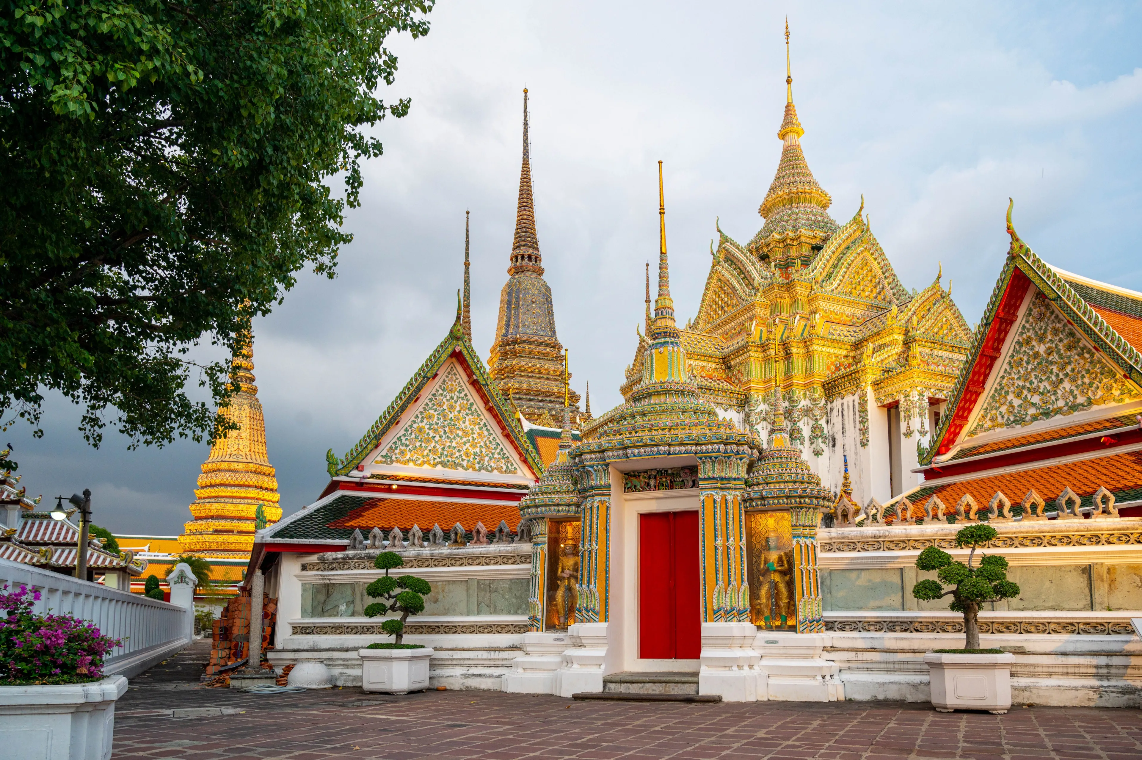 Beautiful view of Wat Pho's ornate architecture in Bangkok, Thailand under a bright sky.