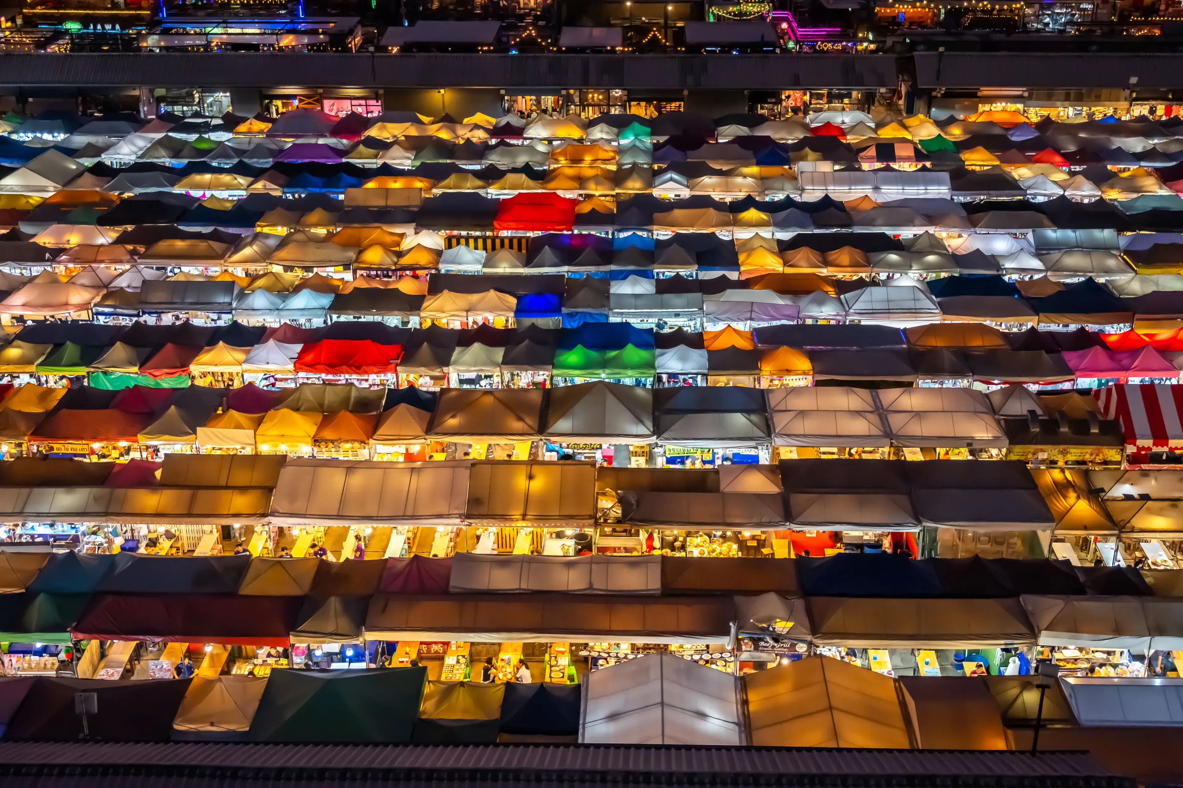 Aerial view of a colorful night market in Bangkok, Thailand. Vibrant stalls create a lively atmosphere Aerial view of a colorful night market in Bangkok, Thailand. Vibrant stalls create a lively atmosphere